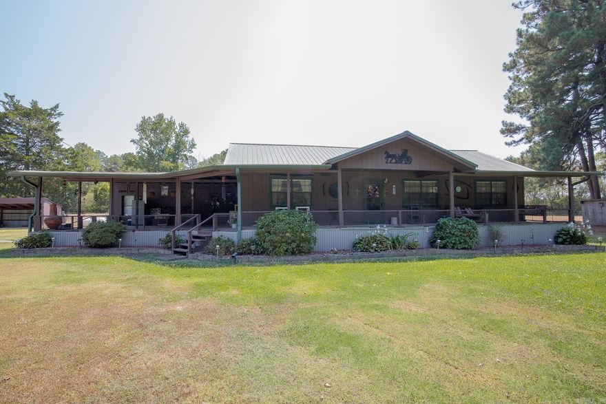 Nice 4 bedroom home-originally a mobile home that has been constructed around and added on to. There are 4 bedrooms, an oversized living room, 2 full bathrooms, dining space and an additional room off of the kitchen.  You'll absolutely love these porches!  What a nice spot to sit and cool off in the shade.  There is a metal roof covering the 2,541 sq ft home and the HVAC was put in around 2021.  Vinyl plank flooring was put in as well.  There is a walk-in closet in the hall, propane fireplace in living room and several wall heaters for back up heat in case of power outage.  Very well-maintained home and property just waiting on a new owner.  Can't beat this for the price!  Under $65 per ft with over an acre of property.