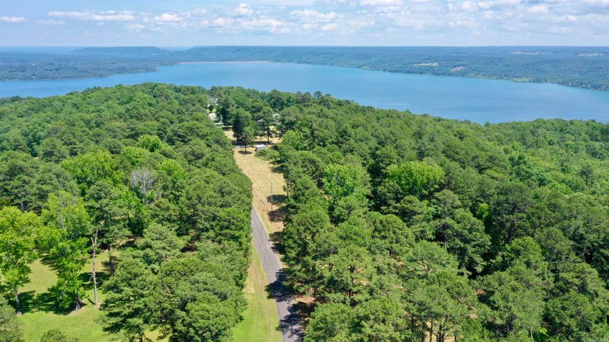 Discover the ideal setting for your dream home on this 5.65-acre property overlooking Greers Ferry Lake and the surrounding mountains. Offering a rare blend of usable acreage and lake views, this lot provides both privacy and convenience. Electricity is already on the property, and water is available at the road, making it ready for your vision to take shape. Located less than 20 minutes from Quitman Public Schools, just 6 minutes from Miller Point Boat Launch, and approximately 20 minutes from Sugarloaf Marina, you’ll have quick access to boating, fishing, and everything Greers Ferry Lake has to offer while still enjoying country living. Come walk the property and experience it for yourself. See drone video Link: https://youtu.be/QgX92JnqqCI