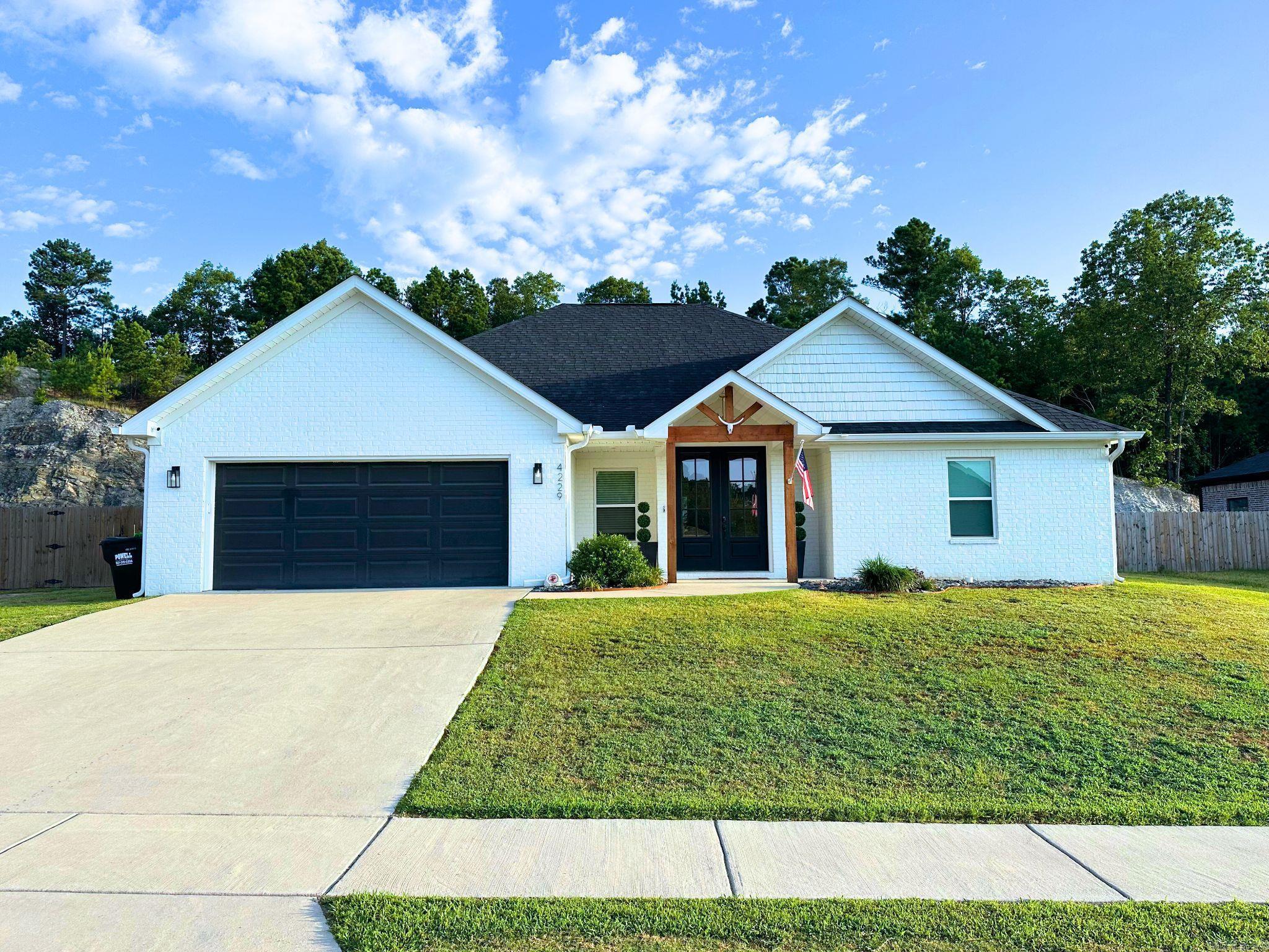 This custom-built 4-bedroom, 2.5-bathroom home is on a nearly 1/2 acre lot with a private feel just a short drive from the center of town. The kitchen boasts quartz countertops, stainless steel appliances, and a hidden walk-in pantry. The DREAMY Primary EN- SUITE is on one side and the other bedrooms are on the other to ensure privacy and comfort for the whole family. The laundry room is connected to the master closet for ease and convenience while also being open to the rest of the house. If you need storage and functionality, the designated mud area and 1/2 bath off the garage entrance are just two examples of just that. This home isn't builder grade- so many adorable custom touches you have to see in person. Out back you can unwind and entertain with the gas grill hookup and private yard ready to make your own. The backyard is quite large and has potential to add a pool, make a large entertaining area or just let the dogs run!
