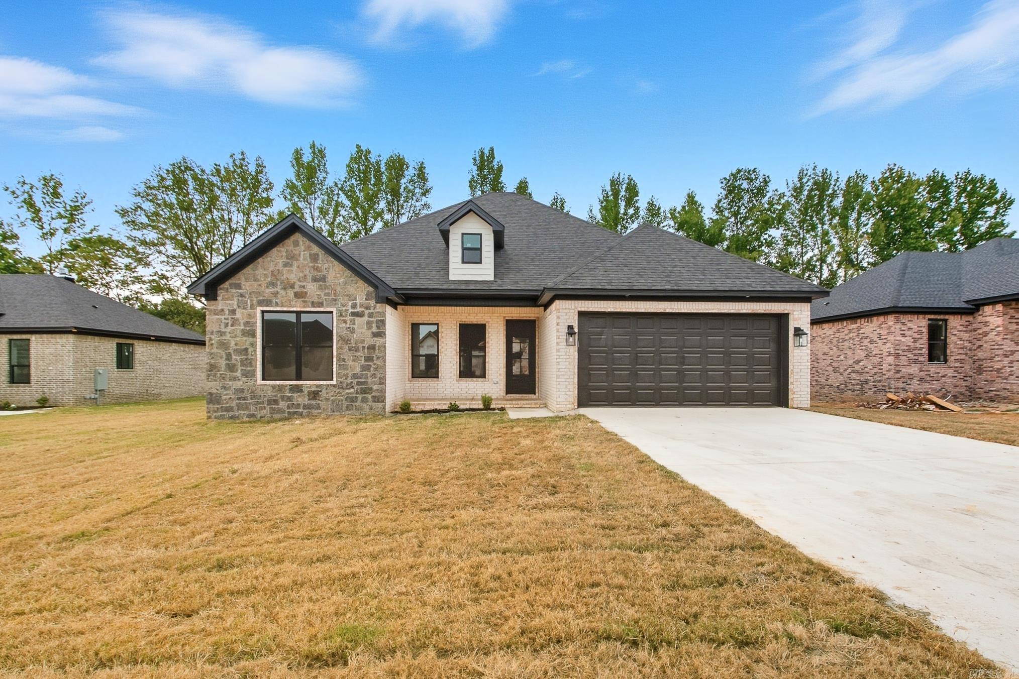 Beautiful new construction in Copper Moon Estates! This 4 bedroom, 2 bath home offers 1,830 sq ft of stylish living space with tall ceilings and an open layout. The kitchen is designed for function and flair with granite countertops, pantry, breakfast bar and stainless appliances, flowing seamlessly into the family room with a cozy wood-burning fireplace. Luxury vinyl plank flooring runs throughout—NO CARPET! The private primary suite includes a spacious walk-in closet, double vanity and walk-in shower. Built with efficiency in mind, this home features walls spray foam insulation, air duct foam insulation, Low-E windows, radiant barrier roof, & higher efficiency air conditioning. Outside, enjoy a covered patio and fully fenced yard, plus a two-car garage. Sitting on a .31-acre lot in the Cabot School District, this home is close to schools, shopping and minutes from nearby highways. Schedule your showing today! Don't miss the opportunity to call this new home yours!