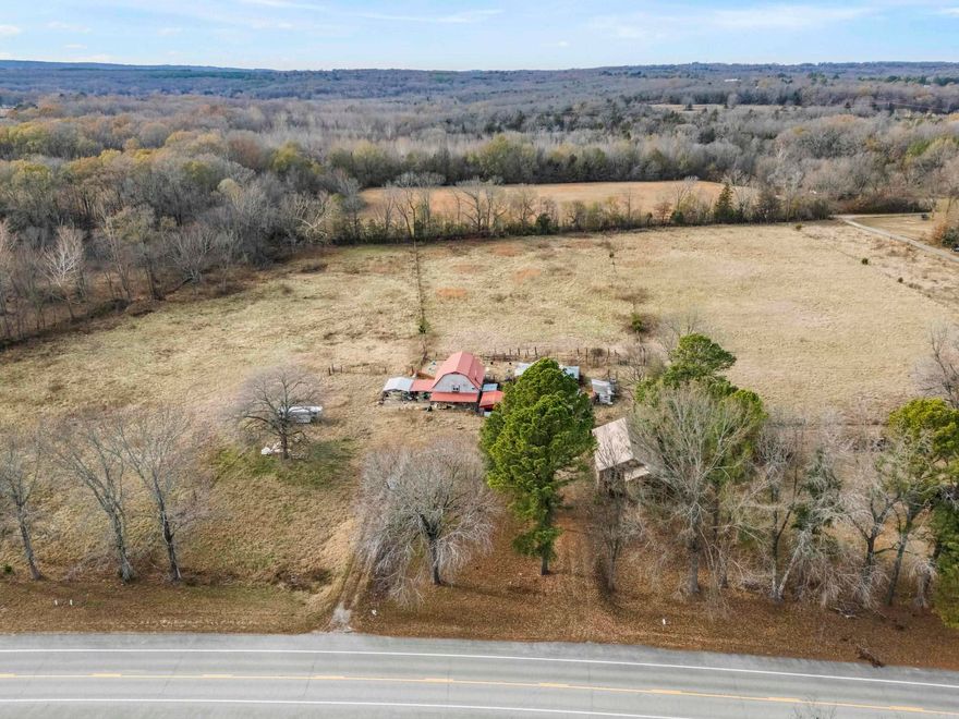 Discover the possibilities with this ±18-acre property featuring beautiful pasture land, a 1,292 sq. ft. 2 bedroom, 1 bathroom home, and several outbuildings including an older shop and barn. The land offers open space, privacy, and room to bring your vision to life—ideal for livestock, hobbies, or a peaceful rural retreat. Fully fenced! Creek runs on property. The home and outbuildings will require TLC and are being sold AS IS. Seller will clean out the house as soon as possible. No seller property disclosure will be provided. Back half is in a flood zone.  Whether you’re looking for acreage, a project property, or a place to build your dream, this tract offers opportunity and charm in a picturesque setting. SEE AGENT REMARKS!