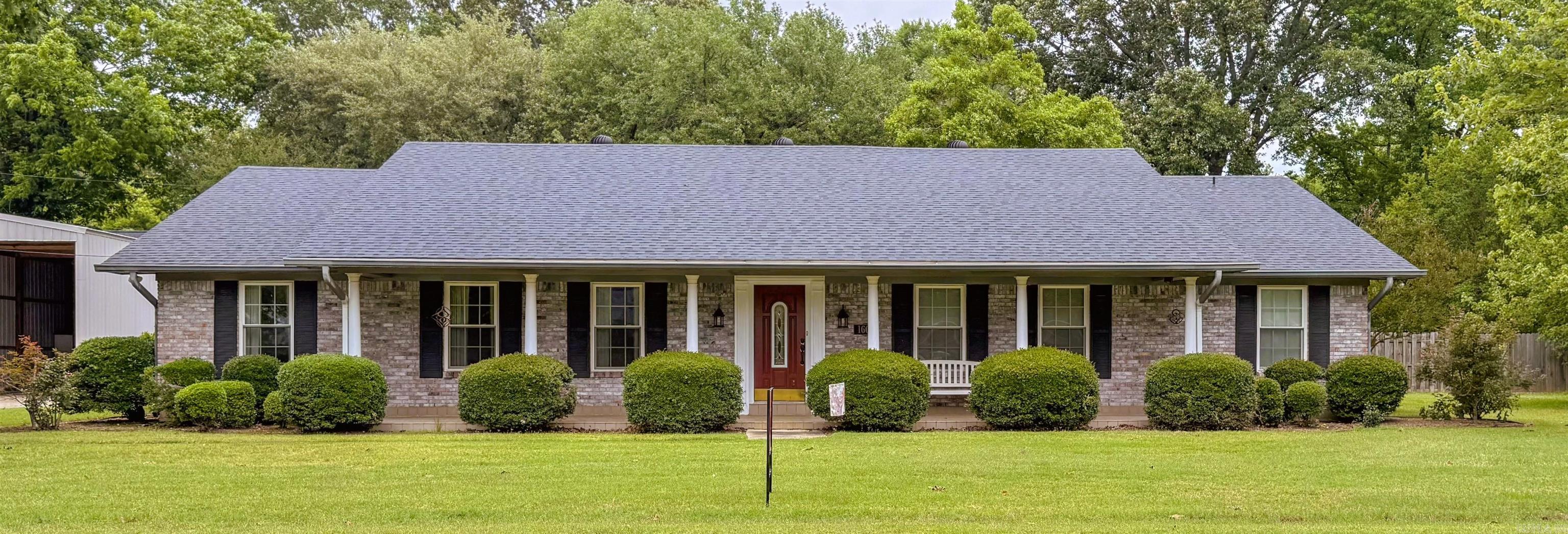 Classic design meets comfortable living with this listing! Located toward the end of a beautiful and quiet street with mature trees, this spacious home offers amazing charm and comfort! This timeless beauty boasts 4 bedrooms and 3.5 bathrooms. A double oven and eat-in breakfast area make the kitchen most desirable. Additional rooms include a formal dining/living room, den area, and spacious laundry room. Each bedroom has double closets, and the master has "his and her" style vanities and closets. Enjoy the remote controlled gas log fireplace in the winter! The back patio and fenced in backyard offers plentiful space to enjoy outside living. Some improvements include: Hardwood floors, insulated windows, new roof in 2021, both HVAC units replaced within past 6 years, French doors, and more! There is a separate shop/storage building AND large covered parking shed, as well. Contact Kara Beth today to view this amazing property and all it has to offer!