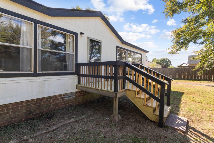 3 bedroom, 2 bath very spacious mobile on permanent foundation sitting on half acre with storm shelter in back yard.  Sits back from the road for more privacy and has a flat big front yard for kids to play.  Backyard has storm shelter for your peace of mind from intense weather.  2 bedrooms, both bathrooms and hallway has new flooring with extra flooring in boxes for you to change the existing original flooring, no carpet in any of the rooms. Living room has wood burning fireplace and plenty of room for your furniture. Large island in the kitchen with lots of windows for the natural lighting.  Has big laundry room with access to outside.  Master bath has large garden tub for your relaxation.  Home is being sold as is with negotiable third party repairs.  Square footage is approx, please measure.