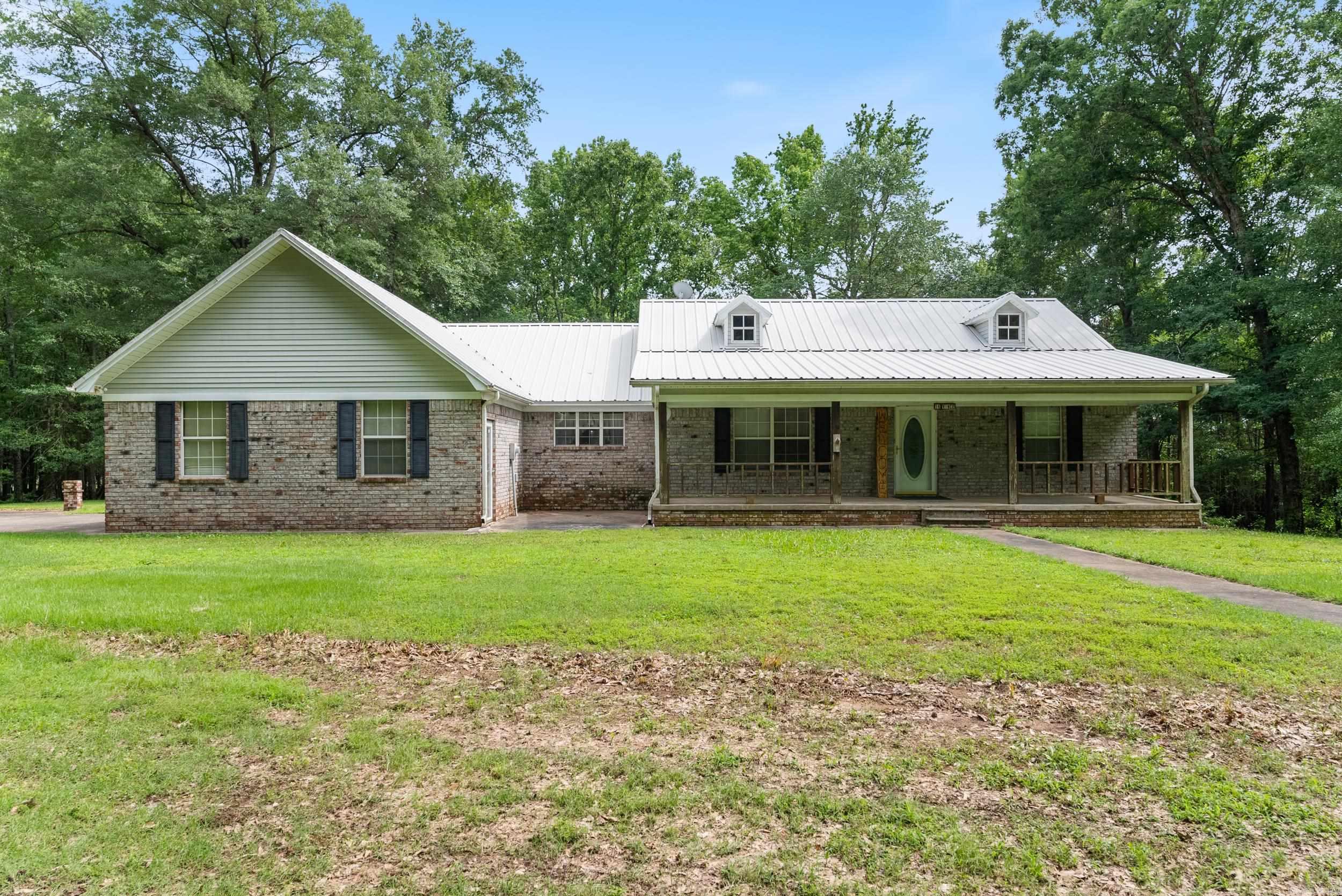 RARE FIND – COUNTRY LIVING JUST MINUTES FROM TOWN! Located just 5 miles outside of Conway, this unique property offers the perfect blend of peaceful country living with the convenience of city amenities—you're just minutes from Sam’s Club and more! This spacious 2,192 sq. ft. home sits on approximately 4.10 acres and features a 2-car garage plus an additional 1-car garage attached to the home. You'll love the added value of a massive 40x60 shop, a detached carport, and a storage shed—plenty of room for hobbies, tools, or extra vehicles. Step inside and imagine the potential, with an approx. 1,450 sq. ft. unfinished basement offering endless possibilities for expansion, a game room, home office, or guest suite. Updates include a new HVAC system (within the last year) and a hot water heater replaced 2 years ago. Enjoy the outdoors under the shade of mature pecan trees, relaxing on the welcoming front porch. Being sold AS-IS — a great opportunity to add your personal touch and build equity. Agents: Please see remarks.