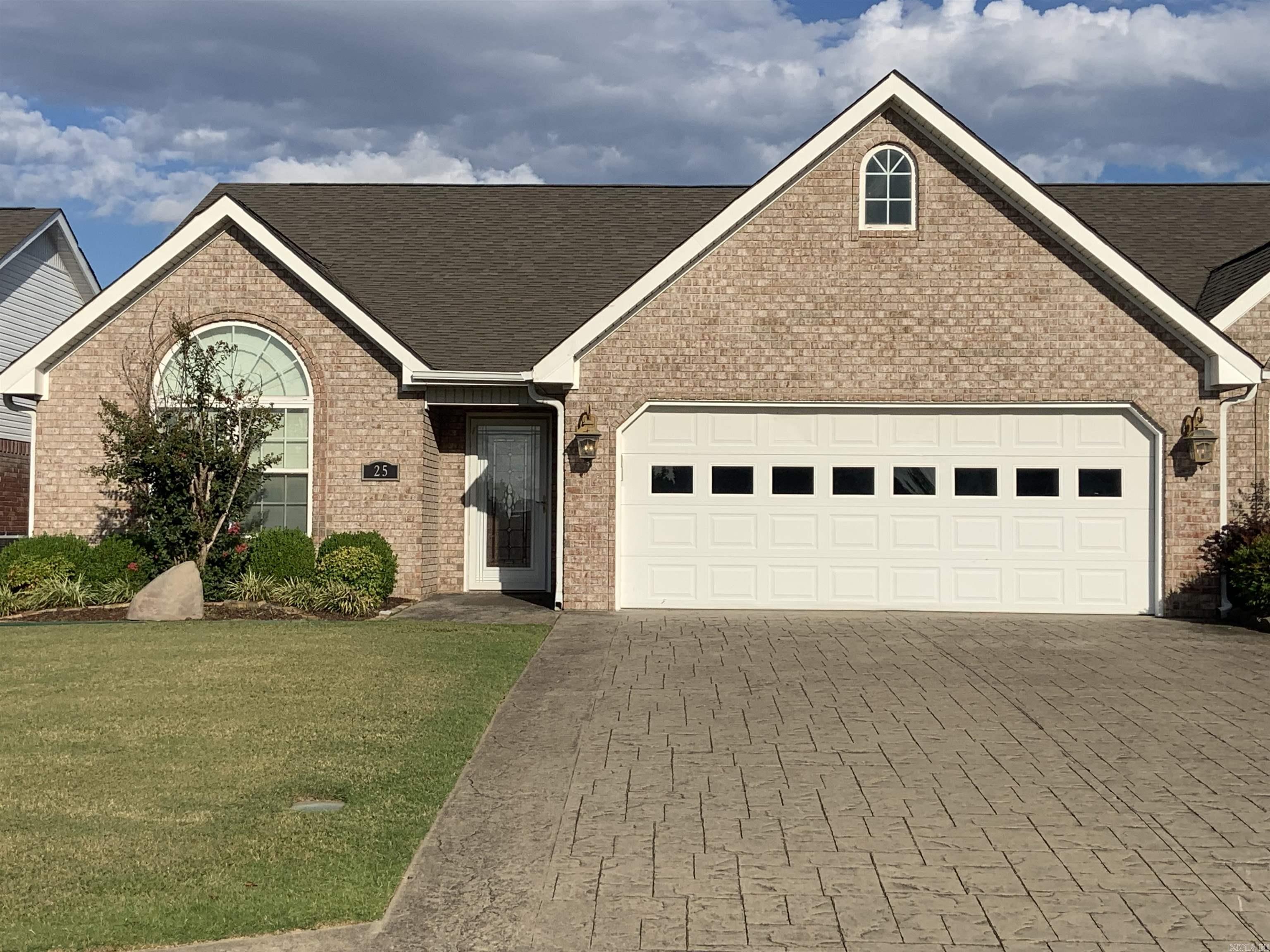 Beautiful Condo, Brick, Stamped driveway. 2BR, 2BA, Lg. Living/Dining Combo w/vaulted ceiling w/sky lights. Built-in Book shelves and cabinets, gas log fireplace. Kit/with all White open top cabinets, formica counters, Stainless appliances including Refrigerator. Breakfast room, heated/cooled sunroom. opens onto a patio. Laundry room includes washer/dryer. Nice pantry. Guest Bedroom with vaulted ceiling, circle head window, hall bath w/tub/shower combo, beautiful vanity sink cabinet. Primary bedroom w/bay window. bath with double vanity and separate shower, lg. walk-in closet. hardwood and tile through out. Window coverings to remain. See Agent remarks