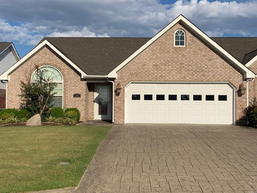 Beautiful Condo, Brick, Stamped driveway.  2BR, 2BA,  Lg. Living/Dining Combo w/vaulted ceiling w/sky lights. Built-in Book shelves and cabinets, gas log fireplace. Kit/with all White open top cabinets, formica counters, Stainless appliances including Refrigerator. Breakfast room, heated/cooled sunroom. opens onto a patio.  Laundry room includes washer/dryer.  Nice pantry.  Guest Bedroom with vaulted ceiling, circle head window, hall bath w/tub/shower combo, beautiful vanity  sink cabinet. Primary bedroom w/bay window. bath with double vanity and separate shower, lg. walk-in closet.  hardwood and tile through out.  Window coverings to remain.  See Agent remarks