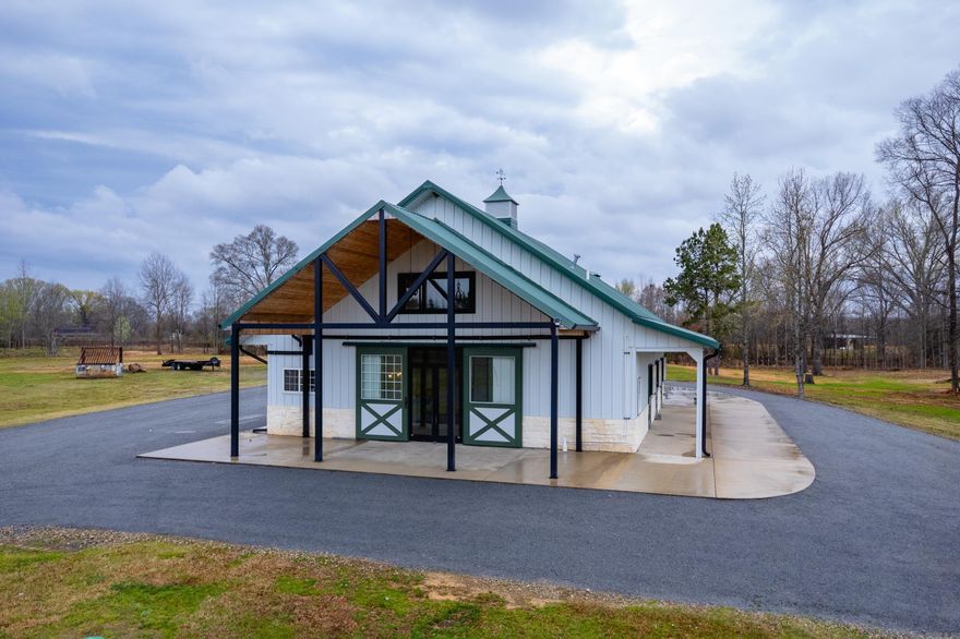 Private barndominium retreat on approximately 71 acres behind a gated entry featuring a mix of pasture, timber, and open land. The property includes a pond and offers privacy, abundant wildlife, and plenty of space for recreation, livestock, or enjoying the surrounding countryside. There is also room to build an additional home if desired. The main living area features an open kitchen, dining, and living space with vaulted wood ceilings, abundant cabinetry, tons of counter space, and stainless appliances. Two bedrooms and a large bath with tiled wet room and soaker tub on the main level. A standout feature is the attached garage/recreation space with soaring wood ceilings, oversized glass garage doors, and flexible space for equipment, hobbies, or a full home gym. The area also includes a fireplace and seating area for indoor and outdoor gathering. Upstairs, the spacious primary suite offers a private retreat with sitting area, kitchenette, laundry, walk in closet, and bath with tiled shower. Windows overlook the acreage and surrounding countryside and is high fenced on three sides ($400k). This property has flexibility for residential, recreational, or agricultural use. Come see!