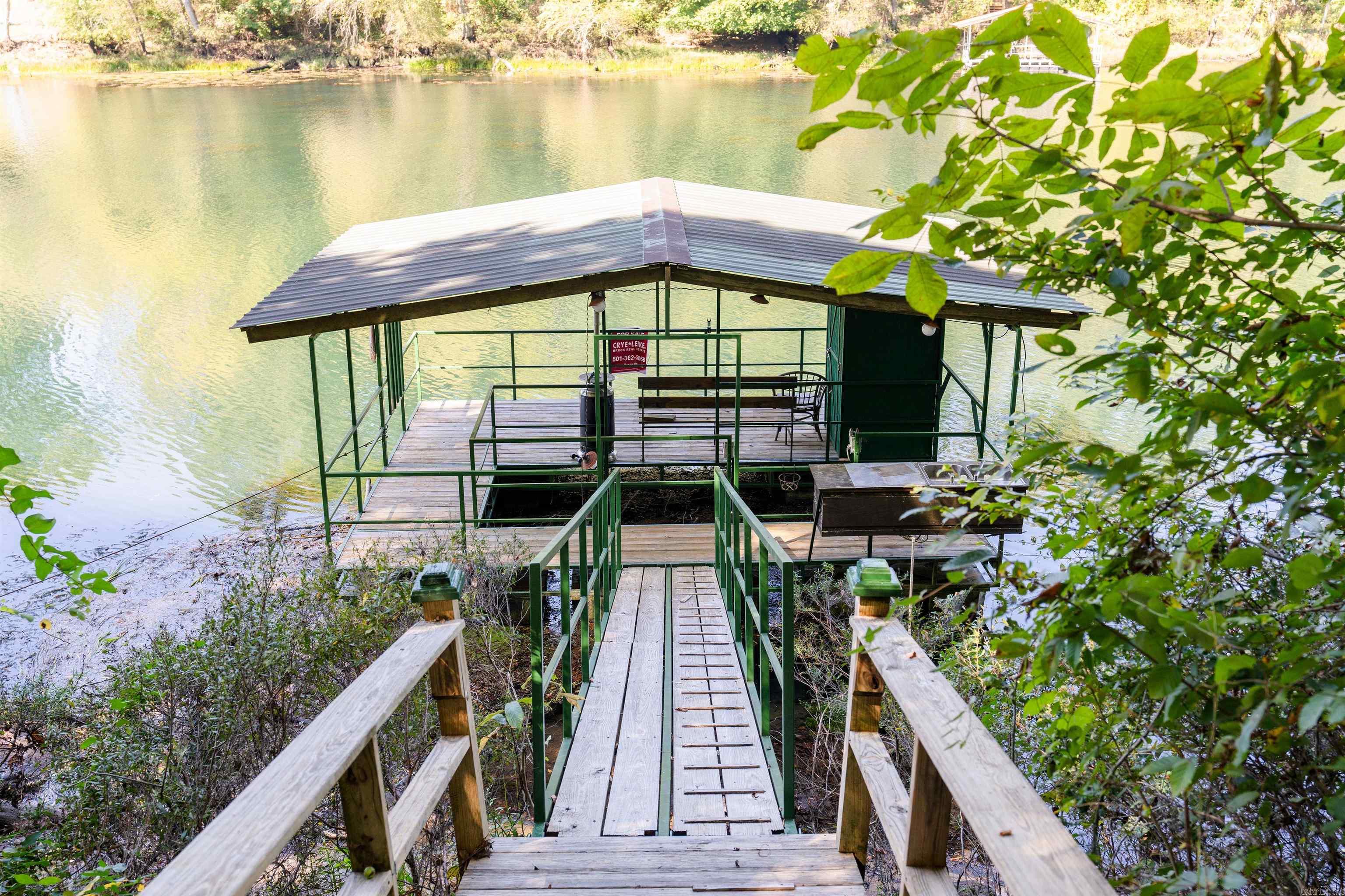 This property is one of the best fishing spots on the Beautiful Little Red River. The guides from Lindsay's Resort tie up on the dock for their clients to fish here! Property is 1.18 acres with 217 feet of river frontage. River lot already has water and electric also a 50- or 30-amp breaker for your camper. It's ready for all of your camping and fishing needs. It also has two beautiful lots right across the street from the dock. Property has a platted road going up to the lots. Once on the bluff you have incredible views of the river. Property has a great spot to build your forever home on the bluff. The lots have been perked for a 1-bedroom septic system or a 3-bedroom drip system. Water and electric at the road.