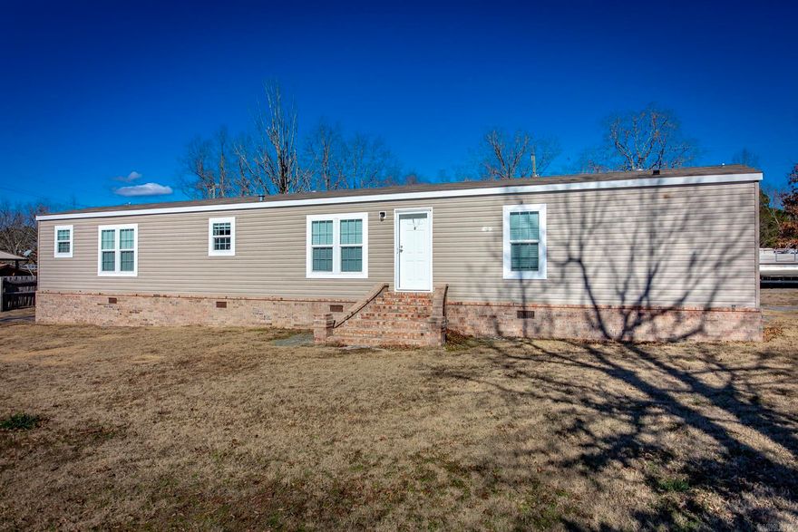 Like New Mobile home - Built in 2022 & Being sold Furnished. Sits on approximately .53 acres +/- & located only 1 mile from "Peter's Sugarloaf Marina".  Home is fenced on all 3 sides, has LVP flooring throughout & has a split floorplan with the primary bedroom on one side with Deep Soaker tub, walk in shower & double vanity and on the other side of the home has two more Guest Bedrooms with another full bathroom.  Laundry room located off of the kitchen that utilizes well as a mud room coming off the back door where there is plenty of parking space for your watercrafts and lake toys (also plenty of room to build a detached shop/garage).  See mobile home title info under "docs"