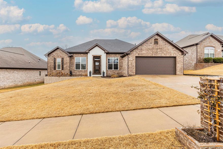 Welcome to your dream home! This distinctive 4BR, 2.5BA gem offers a perfect blend of comfort and style with its thoughtful split floor plan. The open-concept design in the kitchen, living, and dining areas, complete with high ceilings, creates an inviting space for family gatherings around the cozy fireplace. The kitchen is a chef's delight, featuring a large walk-in pantry, gas stove, beautiful cabinetry, a breakfast bar, and a convenient coffee bar. The primary bedroom is a luxurious retreat with a wood tray ceiling, a spacious walk-in closet, a luxurious bath with a tile shower, soaking tub. This home stands out with custom features, including incredible lighting, a walk-up attic for ample storage, a coffered ceiling in the dining room, and a distinctive wood ceiling in the entry.  Mudroom off garage features a halltree for shoes and coats. There is a covered patio with an extended deck overlooking the fully fenced yard, a salt water pool and gardening spaces. Don't miss your chance to grab this one, it won't last long! SF is estimated.