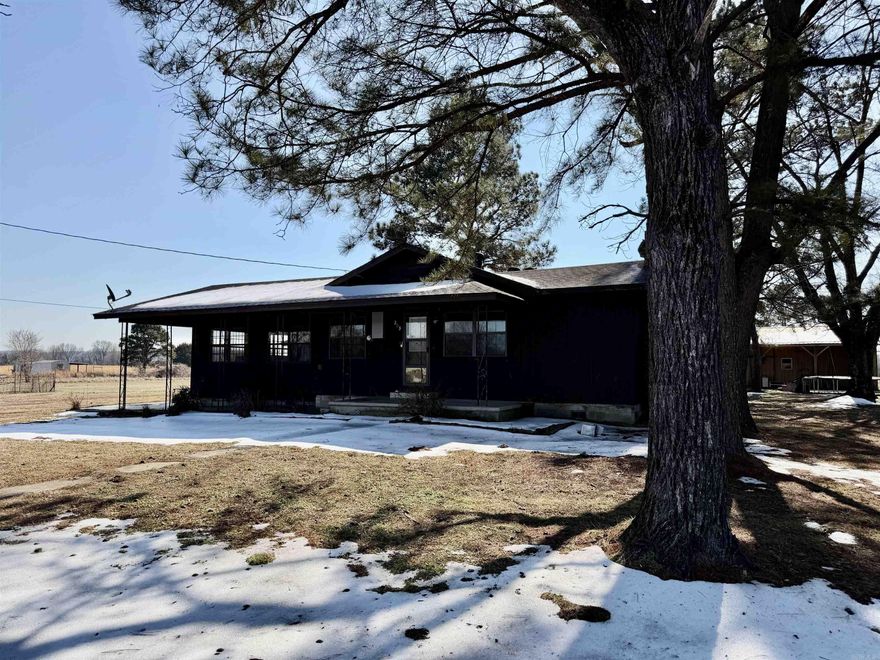 Mini farm on 7.5 acres of fenced pasture with a private setting and only one neighbor, overlooking rolling pastures and mature shade trees. Property includes multiple outbuildings for abundant storage, including a storage building and a barn/shop with lean-tos, horse stalls, and a tack room. Enjoy an expanding covered front porch, a double detached carport plus a single attached carport, and plenty of room for equipment and livestock. Interior updates include renovated bathrooms and kitchen, fresh paint, new flooring, fixtures, and more. Fully equipped galley kitchen features stainless steel appliances, and the cozy living area offers a fireplace—perfect for relaxing after a day outdoors.  One of the small buildings is set up for a beauty salon.  *Note den/sun room/3rd bedroom.