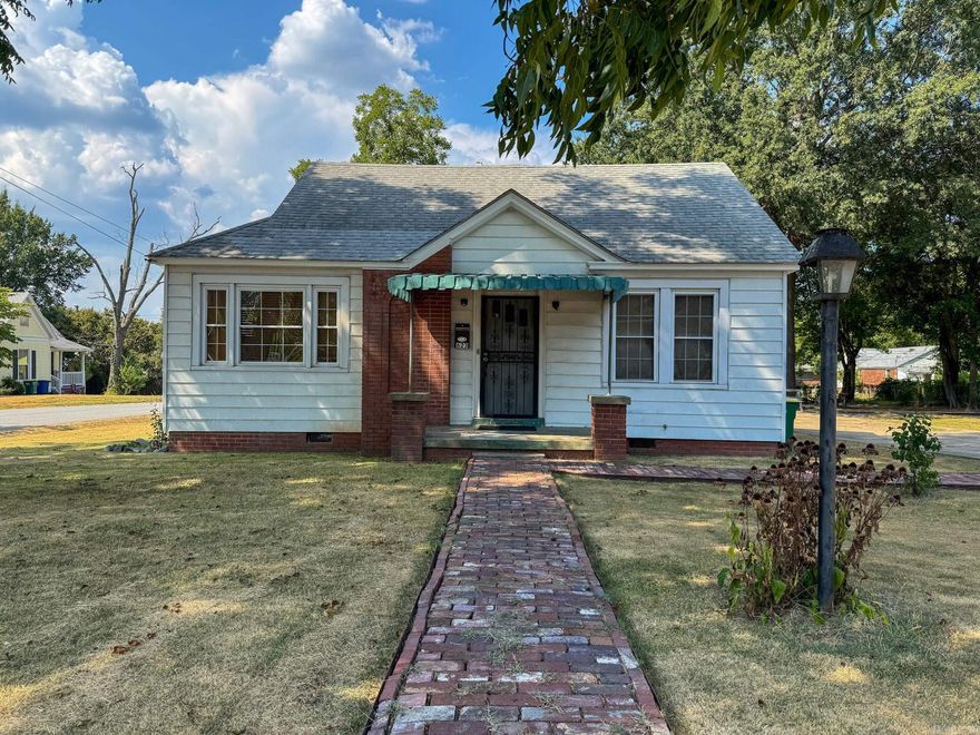 Precious home with lots of updates & a huge yard with shade trees! New HVAC 2025, WH 2020, Roof w/architectural shingles-2015, New plumbing & electrical updates. All but 1 window has been updated w/vinyl double hung windows. Enter into the living room with 9' ceilings, original hardwood floors & a fireplace with gas insert. Move through into the dining space and check out the sitting room which could be a 3rd bedroom. The beautiful kitchen boasts Lyndale Hickory custom cabinetry & granite countertops with tile backsplash. Appliances are approximately 8 years old. The laundry room is conveniently located off the kitchen. The two bedrooms are spacious & each is connected to a bathroom. Both bathrooms have been updated with luxury vinyl plank flooring & new vanities. A lovely shower with tile surround is included in one bath with a tub/shower in the other. The detached 3 car garage has a 1 bedroom apartment which is a great income property. The apartment has 2 window units & a floor furnace. Apartment includes original hardwood floors & new water heater. The home sits on two lots which leaves the option for adding a home to the second lot. Great income potential! Agents, see remarks.