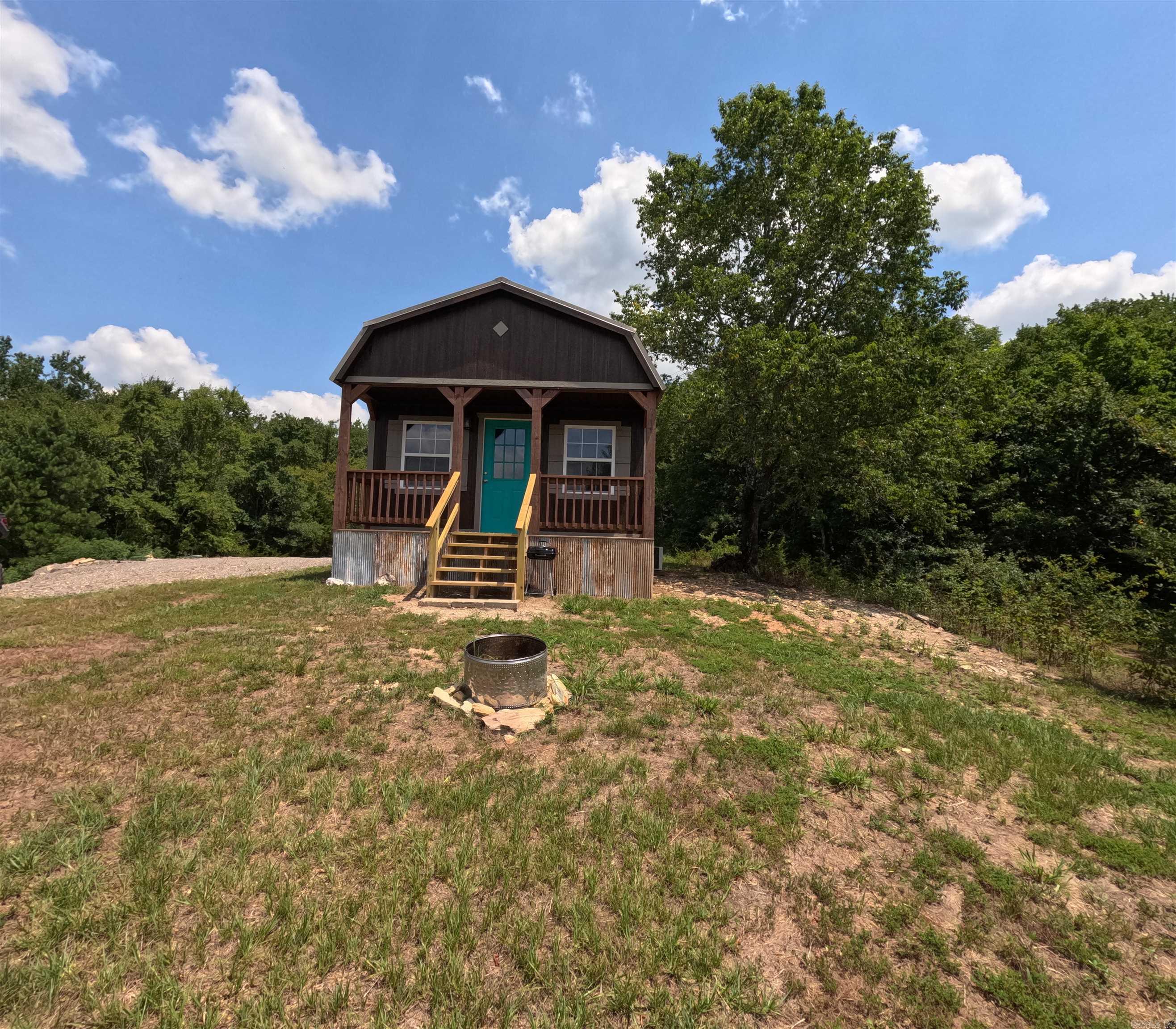 Looking for your own piece of Tranquility with all of the necessities? This BRAND NEW 512 SQ FT cabin with a 250 SQ FT loft sits on a beautiful 12.53 acres. Located far enough away to be quiet but, within riding distance of WOLF PIN GAP trail system! This gem boasts butcher block counter tops, ship lap walls, old barn tin ceilings, a walk-in shower, built-in storage, and NEW appliances. The open concept allows space to pack in the party or enjoy the peace and quiet alone! The hillside is mixed with mature hard woods, tall pine trees, and a year-round creek. The wild life is abundant! The gravel pad next to the cabin is equipped with a clean out for the sewer making it a perfect spot to set up an RV or Travel Trailer. Also, 2 other build sites have been leveled if you are looking for an investment property for short-term rentals. Agents see Documents.