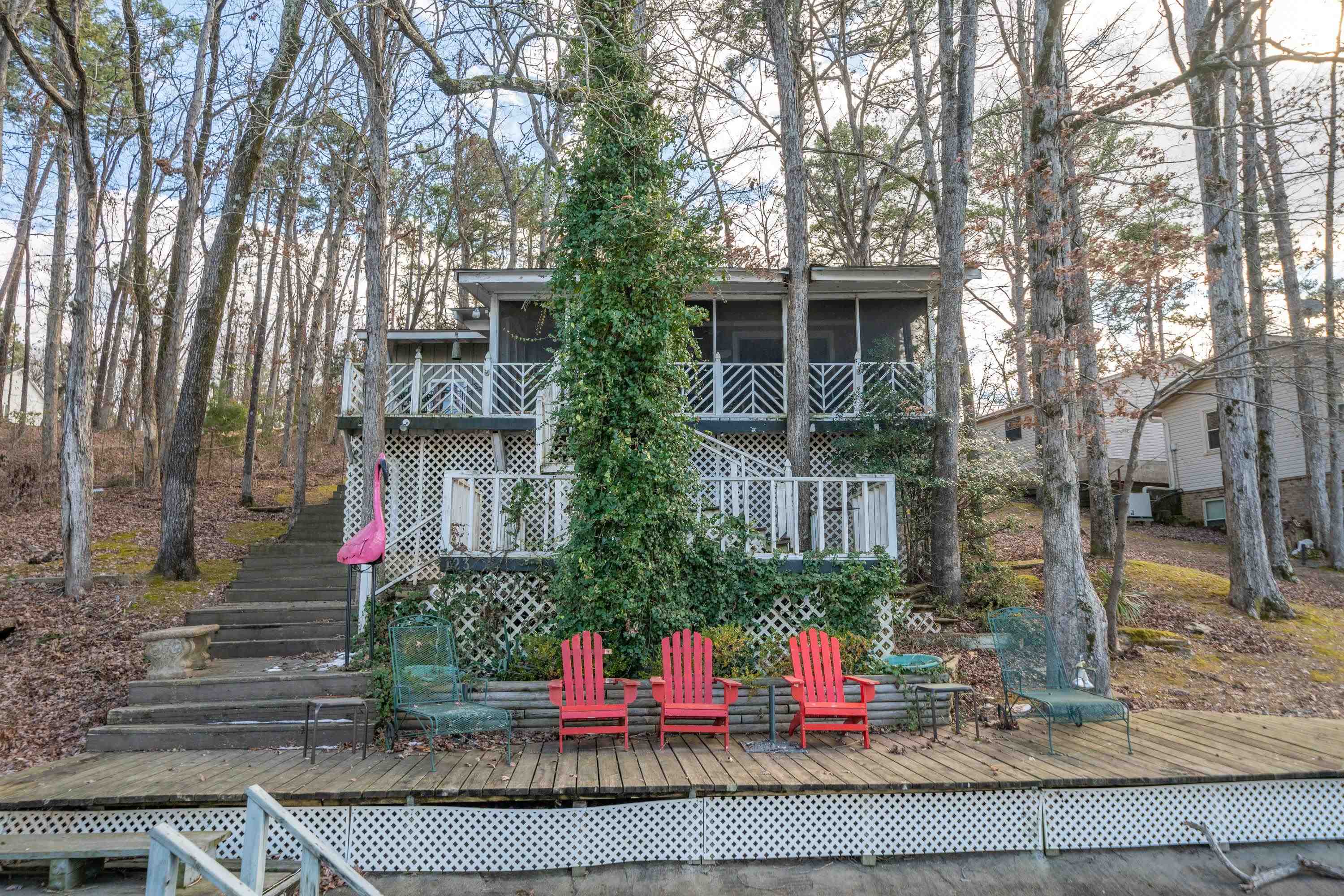 Step into this quintessential lake cabin and experience the charm of lakeside living located off of Long Island Drive / Hwy 7S! This 2-bedroom, 1-bathroom home features an inviting eat-in kitchen and a cozy living room centered around a wood-burning fireplace.. Both bedrooms open onto a screened-in deck, offering serene views and the perfect space for relaxation. Located on the Lake Hamilton with 75ā of lake frontage, this home is perfect for enjoying serene water views and a laid-back lifestyle. The cabinās interior boasts warm wood-lined walls throughout, enhancing its cozy, rustic appeal. Enjoy breathtaking views of the main channel from your screened deck or take advantage of the two-stall dock, complete with a lift and swim platformāideal for boating, swimming, or simply soaking up the lake life. This home is a true gem for anyone seeking the perfect lakeside retreat. Donāt miss the opportunity to own a piece of Lake Hamiltonās beauty! *New roof 2023
