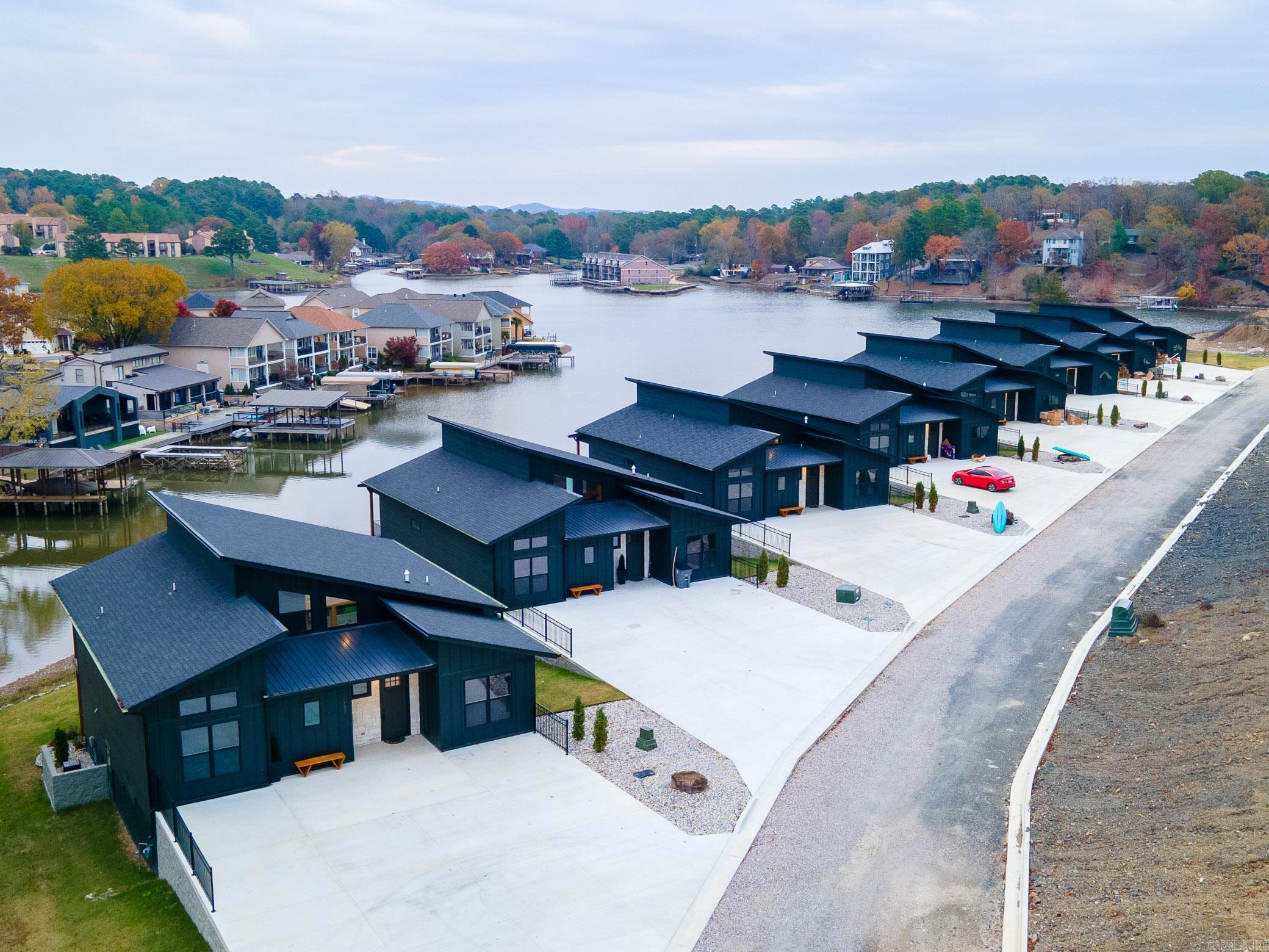 Discover an unparalleled investment opportunity with 8 brand-new luxury lakefront homes, ideally located in the vibrant and historic town of Hot Springs, Arkansas. These breathtaking properties combine waterfront tranquility with proximity to some of the region's most iconic attractions, offering the perfect blend of relaxation and excitement. Each home features 7 spacious bedrooms, 4 luxurious bathrooms, sleeping 16 people per home, two expansive living areas, a private home theater, and an elevated second-story deck with sweeping lake views. Enjoy year-round comfort with a private heated pool for each residence and seamless lake access via dedicated boat slips. Situated just minutes from Hot Springsā most popular attractions, these homes offer unmatched convenience. Guests can experience the thrills of Oaklawn Racing Casino Resort, the charm and history of Bathhouse Row, the natural beauty of Garvan Woodland Gardens, and the scenic splendor of Hot Springs National Park. With a projected annual income of $1.2 million, this development is a rare opportunity for investors looking to secure a lucrative vacation rental portfolio. *Income & expenses are estimates. *