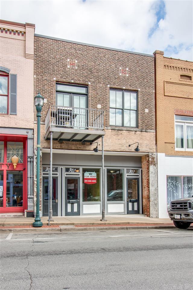 Welcome to the Rental Market 304 S. Main St., Ste A of Downtown Jonesboro, AR. A historic gem, rich in character and history. Location, location, location! This property is located across the street from Omar's Uptown and surrounded by professional offices, and fine retail & dining establishments. Conveniently located with quick access to anywhere you need to be in town. The front exterior features a contemporary color palette of black, white, and gray and offers a large store front window for displays. Around back there is an additional entrance to the building and a common use deck. Inside you will find 900 sf. of well laid out and usable space. A front reception/lobby area followed by a long and wide space for desks. The lounge area holds a half bath, eating area, refrigerator, sink, cabinets, and countertop space. There is plenty of space for storage with two large storage rooms. Designed and crafted with love, this one of a kind retail space offers soaring high ceilings, gorgeous chandeliers, a rich color scheme, original hardwood floors, and is wired for your business needs. Schedule your tour and sign your lease. Owner is a licensed real estate broker. Available 8.1.25.
