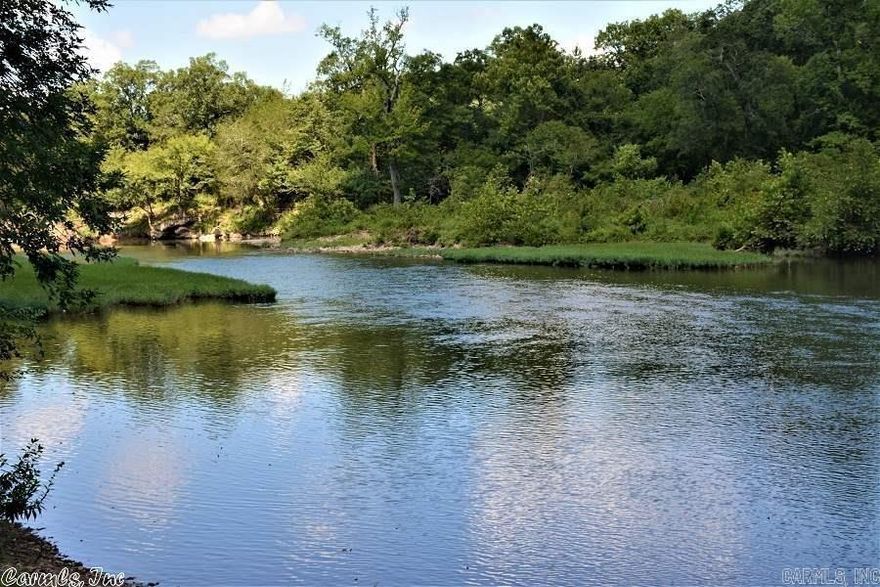 This 45.11± acre waterfront property features approximately 1,433 feet of frontage on both sides of the Ouachita River, offering scenic river views and a beautiful natural setting. A portion of the land on the north side of the river adjoins U.S. Forest Service property.  The combination of river frontage and land classified as USDA prime farmland, along with established pecan trees, creates a versatile landscape with outstanding potential. Existing improvements include two 30x300 chicken house pads, a 42x52 utility building, and an RV hookup with power, septic, and well access (RV does not convey). With three wells, power, and septic in place, the property is well-positioned to support a variety of uses, activities, and outdoor enjoyment.  For outdoor recreation, a well-known float begins at the Shirley Creek Recreation Site and continues downstream to the Oden Access area, approximately four miles away. Those familiar with this stretch of river will immediately recognize the setting. The property is well suited for canoeing, kayaking, fishing, and enjoying the relaxed, scenic character of this portion of the Ouachita River. Shown by appointment only. Please do not access property