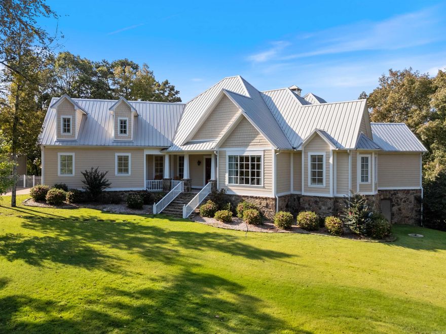 Welcome home to this peaceful estate nestled on 3.65 acres within a private, gated community with stunning views of Greers Ferry Lake. This custom-built home boasts timeless architecture and high-end finishes throughout, providing the ultimate lake living experience. The two-story great room features a vaulted ceiling with wood accents, wood burning fireplace, and expansive windows providing a picturesque view of the Lake. The gourmet kitchen features stainless appliances, an abundance of cabinets, pantry, breakfast bar and dining room with access to the cozy screened-in porch with fireplace and spacious outdoor entertaining space. The primary suite is the definition of a retreat, with its own private patio, sitting room, spacious bathroom featuring a copper soak tub, walk-in shower, dual vanities and private water closet. The main level also includes a second bedroom suite. The second level offers three bedrooms and 2.5 bathrooms. Incredible outdoor entertaining areas offer covered and uncovered spaces and beautifully landscaped grounds. Other features: new generator and audio-visual system, an attached garage and detached garage offer space for 4 cars and a 25ft boat plus more!