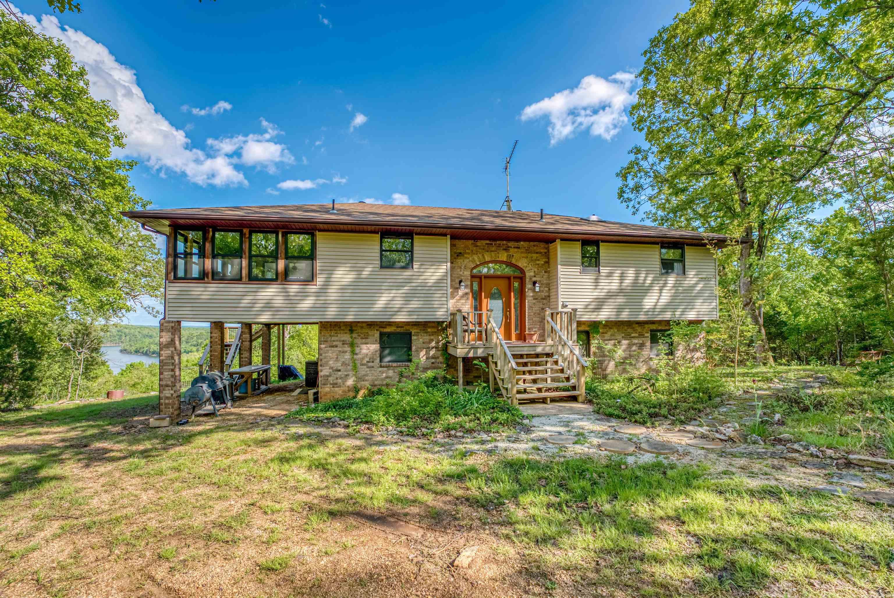 Stunning Split-Level Retreat on 9 Acres with Lake Norfork Views Discover your dream home perched on 9 sprawling acres, offering breathtaking, expansive views of Lake Norfork. This meticulously maintained split-level residence blends modern updates with serene surroundings, perfect for tranquil living or entertaining. A bright & airy sunroom has been upgraded with new windows, flooding the space with natural light and showcasing panoramic lake views. A luxurious Master Suite features a fully updated bathroom for a spa-like experience. Fresh and modern interior include paint and flooring to create a crisp, inviting atmosphere. Equipped with a new water softener and on-demand hot water heater for ultimate comfort. HVAC units updated in 2015 and 2022 for year-round efficiency and new appliances. The versatile basement includes a bonus living area with a walk-out deck, ideal for gatherings or quiet relaxation. Expansive 9-Acre Lot that is perfect for outdoor enthusiasts, with ample space for recreation, gardening, or simply soaking in the serene lake vistas. Whether you're seeking a peaceful retreat or a forever home, this Lake Norfork home is for you.