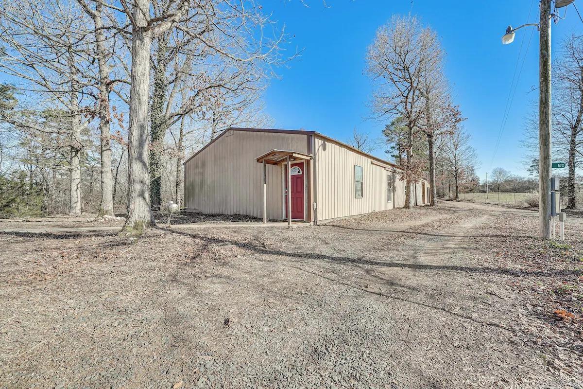 SPACIOUS BARNDOMINIUM in great location with HUGE garage, a shop area, and additional building pad with all the hook-ups needed already in place!!! Very well built with 2" X 6" solid construction. The attached garage is almost as big as the 4 bedroom 1 bath house! The living room in this home is very spacious and has an open concept feeling to the kitchen area and even has a wet bar ready to host your guests. It was previously set up for an AIRB&B and is in a great location being in BOARD CAMP area close to ATV trails, close to the Ouachita National Forest, but still close to town and the new Bike Trails! Feels very private and sits on almost 3 acres! This would be a great investment property, room for additional buildings, weekend getaway or be used for a primary residence! Seller will pay $10,000 towards Buyers closing costs and/or prepaids. MOTIVATED SELLER.