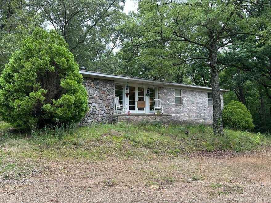 Just south of Hot Springs Village - quiet country living! 3 bedrooms and 2 baths and over an acre of space! Pretty French doors off of the living room. Roomy kitchen with breakfast bar. Great covered patio out back! No seller property disclosure.
