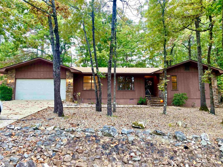 OPEN HOUSE SUNDAY 2-4pm! This late 70's built home is so WELL PRESERVED, you'll feel like a kid again. It has All the cool 70's features, and an earthy "cabin" feel that's very cozy and warm. The slate floor entry is so inviting, as well as the large stone fireplace with wonderful built ins. The kitchen will have you reminiscing with the mint condition butcher block countertops and cool hardware...and the show stopper is the saloon doors going into the dining room. The large sliding glass door in the den takes you out to a BRAND NEW 20 foot DECK...a great place to relax and enjoy nature. Two bedrooms are down the hall and the primary has an en-suite bathroom. You'll appreciate the spacious laundry room with it's own back door, plus a large two car garage. Lake DeSoto is just a short two minute walk, and offers a nice fishing dock. Or bring your golf cart and head to the DeSoto Golf Course nearby.  Come fall in love with the 70's all over again, this home is amazing, and its comes with a new roof and hvac too!