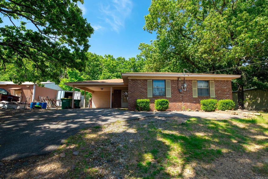 Great earning potential. This 3 bd 1.5 bath home is being sold with the lot next door.  The home features 2 large living areas .There is a metal shop on the lot which is currently renting for $550 mo. House has been rented to last tenant for several years at 850.00 mo.  Roof is 2 years old, hot water heater , stove and sewer lines have been replaced. Great for investor wanting to add to portfolio or first time home buyer. Home needs paint and carpet. See Agent remarks          Roof is