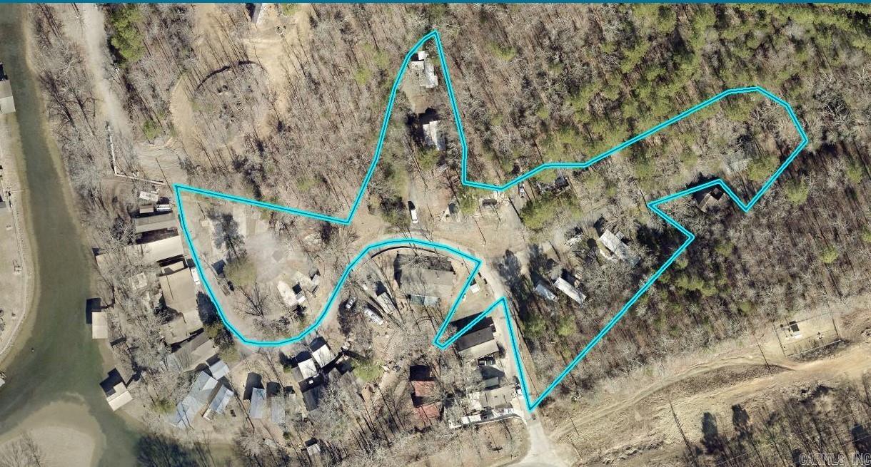 The Possibilities are Endless! Over 3 acres of mostly level land with 25+ pads with individual electrical meters! Perfect for mobile homes, tiny houses, campers, etc! Or build your dream home with lake views! You have to see it to believe it!