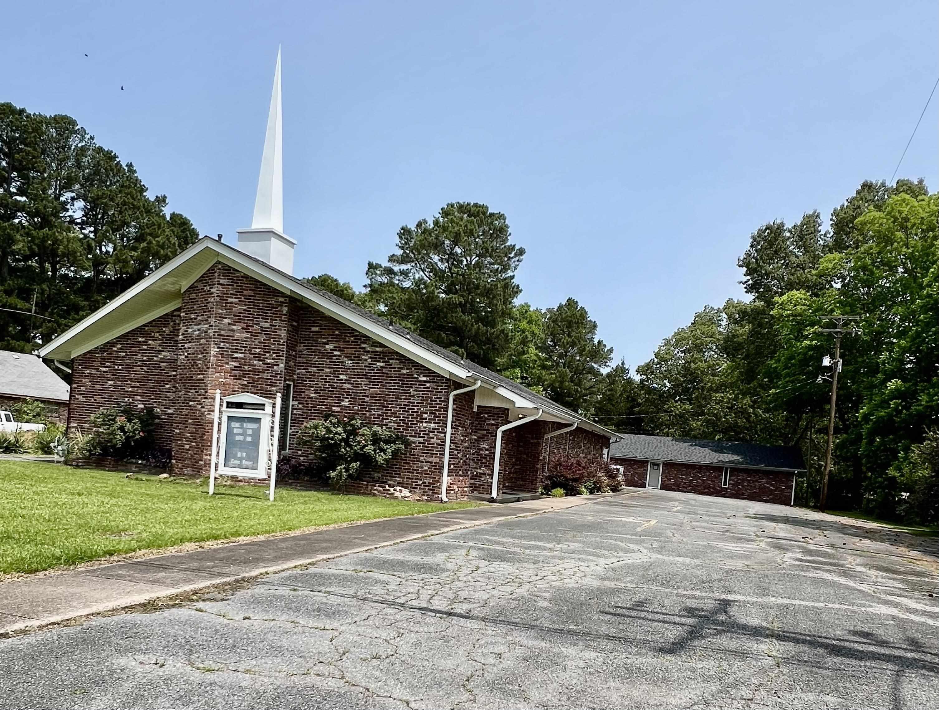 Previous church facility. Any use allowed by seller, check with city planning commission. Over 5k square feet combined space. 3300 SF sanctuary and classroom building and 1980 SF fellowship hall. Appointed offices, classrooms, storage closets, and fellowship hall with full kitchen. 4 restrooms. Asphalt parking. Property being sold as-is present condition. All showings must be accompanied by a Realtor. NO Disclosures provided by seller. Existing personal property will remain but will not be considered part of the sale. Any items left in the building will be considered as-is and abandoned and will have zero value. Seller makes no guarantees, warranties, or representations of any kind regarding the existence, condition, or usability of said personal property which will remain in building at closing. Title transferred by Special Warranty Deed/Trustee Deed.