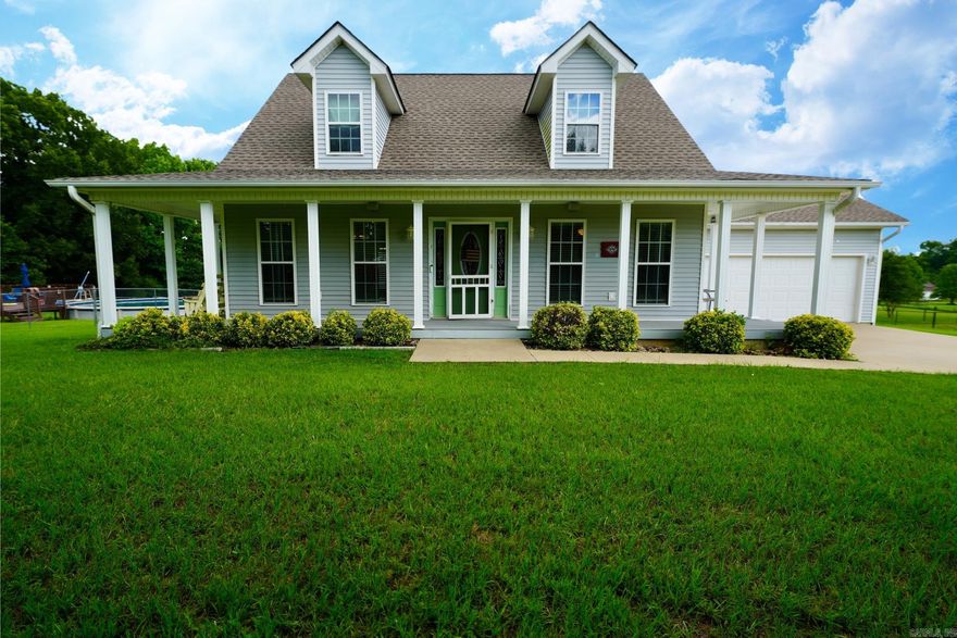 Welcome to this beautifully maintained 3 bedroom, 2.5 bathroom home on an oversized lot just outside the Cabot city limits. Enjoy peaceful country living with the convenience of nearby schools, shopping, and dining. A charming wraparound porch with durable Masonite decking and built-in speakers is perfect for relaxing or entertaining. Step inside to a soaring two-story entryway and gorgeous wild cherry hardwood floors throughout the main living areas. The kitchen offers stainless steel appliances, a pantry, and plenty of cabinet space for all your cooking needs. The primary suite is conveniently located on the main floor, while two additional bedrooms upstairs share a Jack and Jill bath. A separate powder room on the first floor is perfect for guests. With a roof less than three years old, a spacious layout, and move-in ready condition, this home has it all — extra space, privacy, and an easy drive to everything Cabot offers.