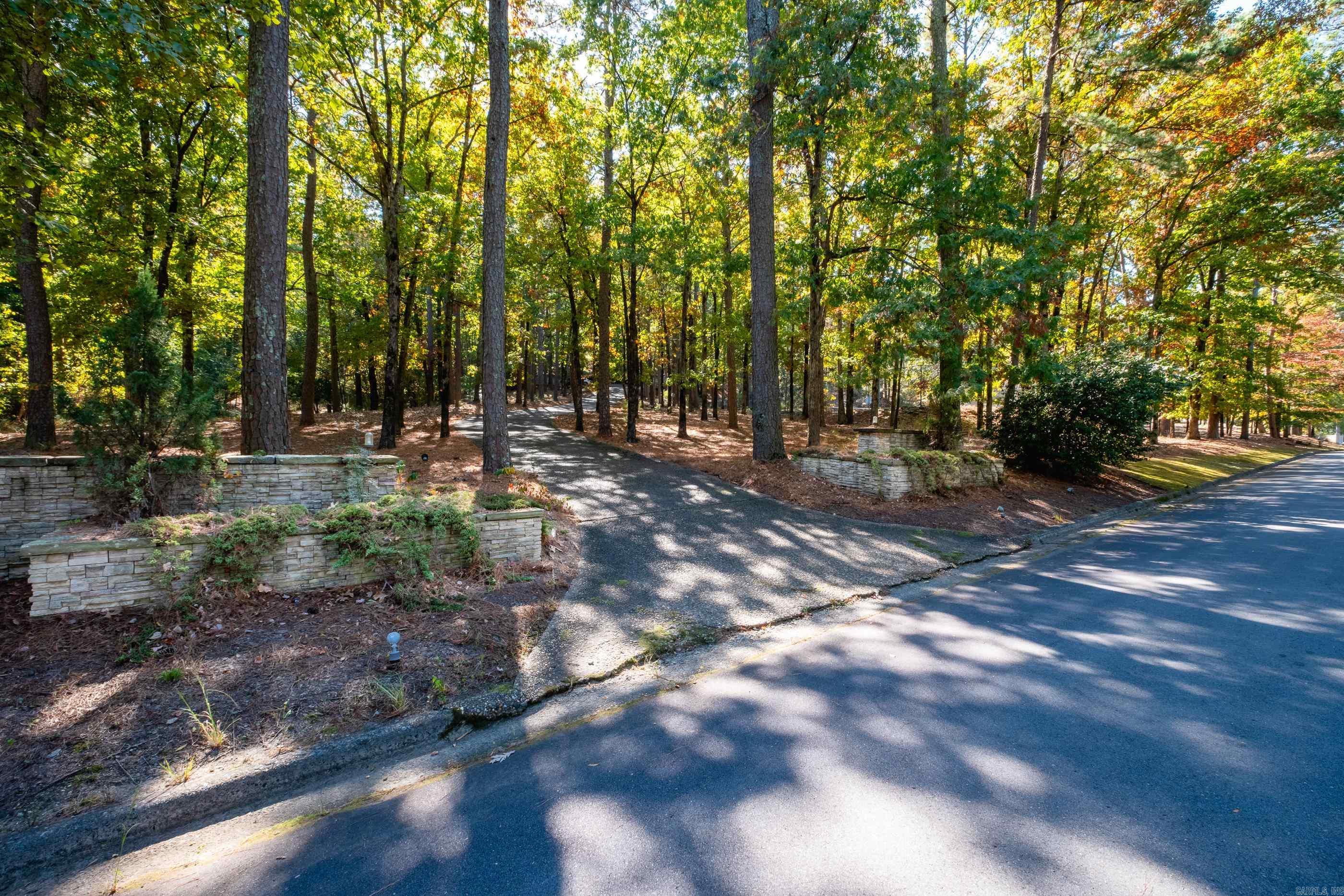 1.62 Acres in the Exclusive Hickory Hills Gated neighborhood in West Little Rock. This property is perfect to build your Dream Home! The lot are surrounded by beautiful estate homes and are located in the heart of West Little Rock. Just minutes from Pleasant Valley Golf Course and many other amenities. There is an existing driveway and tennis court on the property. Do not miss out on this rare opportunity. SEE AGENT REMARKS Additional Lot next to this one available.
