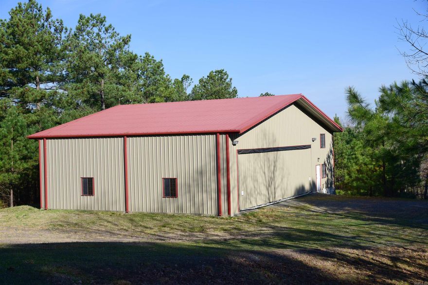 Hangar home in prestigious Holley Mountain Airpark. 70x50 building with 1000 sf of living space that includes 1 bedroom, 1 bathroom, kitchen, living area, office space, and room for one additional bed.  40x12 hangar door, hydraulic lift with remote. 2-car garage and woodworking shop with plumbing on lower level. Underground propane tank storage, fiber optic at the street. Paved 4,800 x 50 foot paved runway, complete with 2 GPS approaches & pilot controlled lighting. Gated community. Close to hiking, mountain biking & ATV trails, golf courses & Greers Ferry Lake.