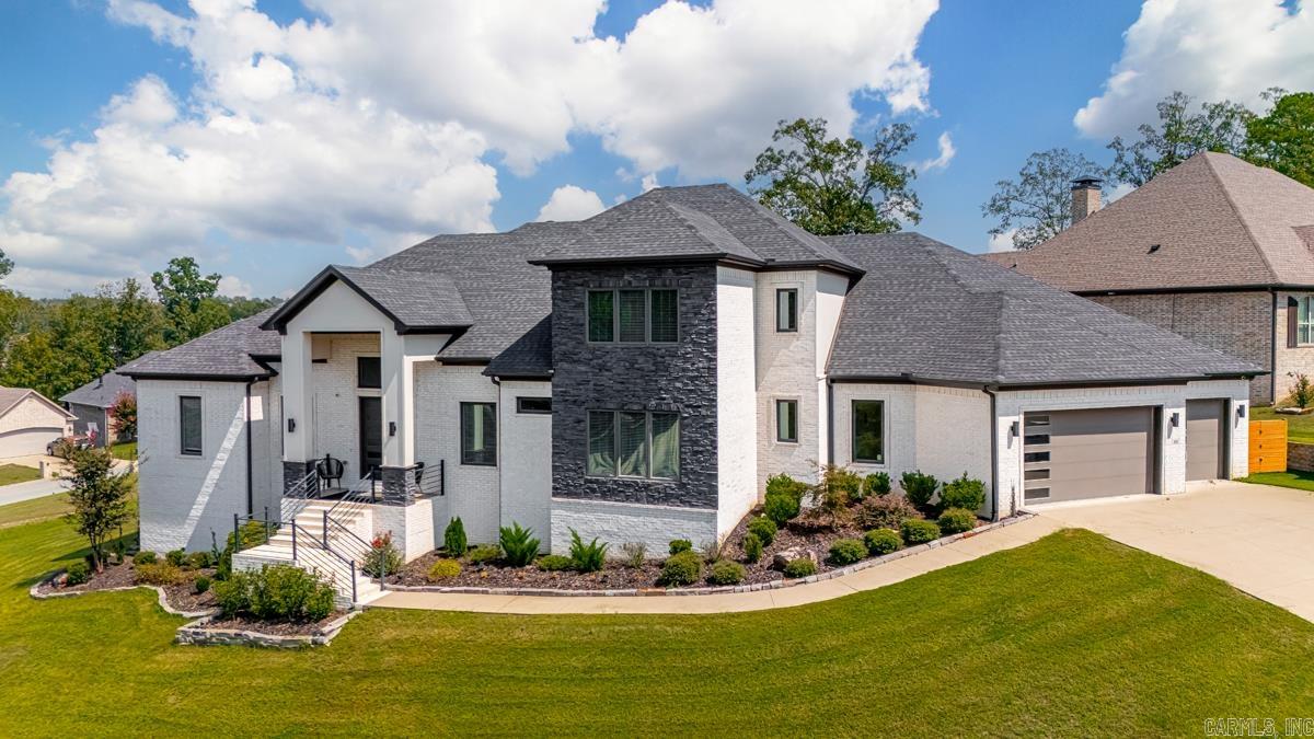 Step into this one-of-a-kind Maumelle retreat on .51 acres, custom crafted in 2019 with every detail in mind. The main level features a primary suite built for relaxation—dual vanities, spa shower, and a walk-in closet with custom storage. A guest suite with private bath, formal dining, and a dedicated office round out the first floor. The gourmet kitchen is the heart of the home with gas cooktop, pot filler, double ovens, dual dishwashers, microwave, and oversized pantry—perfect for both weeknight meals and entertaining crowds. Upstairs, you’ll find two generous bedrooms with en-suite baths and walk-ins plus a large bonus room with projector setup. The lower level adds even more living space with a kitchenette, media/rec room, extra storage, and access to a second garage. Outside, enjoy the covered patio with fireplace and full outdoor kitchen, along with expanded patio space for gatherings. A 3-car garage (with Tesla charger) completes this rare find. Schedule a showing today!