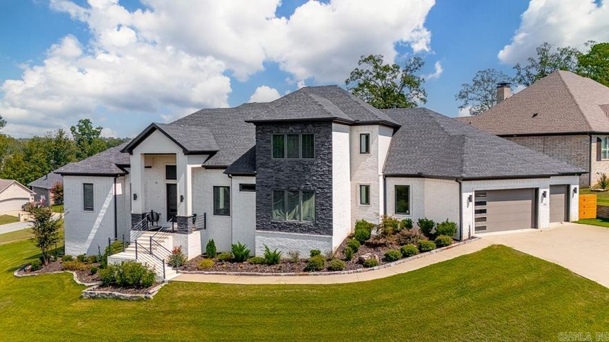 Step into this one-of-a-kind Maumelle retreat on .51 acres, custom crafted in 2019 with every detail in mind. The main level features a primary suite built for relaxation—dual vanities, spa shower, and a walk-in closet with custom storage. A guest suite with private bath, formal dining, and a dedicated office round out the first floor. The gourmet kitchen is the heart of the home with gas cooktop, pot filler, double ovens, dual dishwashers, microwave, and oversized pantry—perfect for both weeknight meals and entertaining crowds. Upstairs, you’ll find two generous bedrooms with en-suite baths and walk-ins plus a large bonus room with projector setup. The lower level adds even more living space with a kitchenette, media/rec room, extra storage, and access to a second garage. Outside, enjoy the covered patio with fireplace and full outdoor kitchen, along with expanded patio space for gatherings. A 3-car garage (with Tesla charger) completes this rare find. Schedule a showing today!