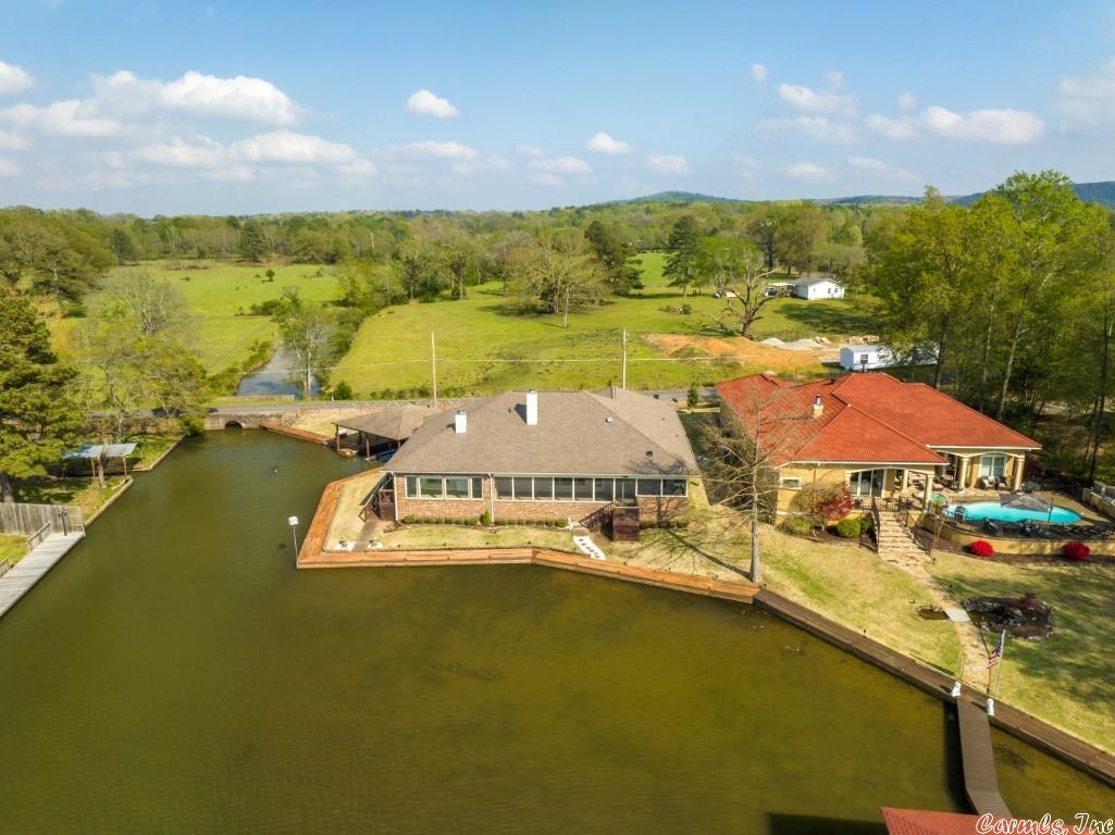 One Level waterfront home with massive lake view and a boardwalk with 2 slip covered dock. Handicap accessible! Alderwood cabinets, Bamboo flooring, tile in kitchen, two fireplaces, sun porch heated and cooled, screened in porch with outdoor kitchen. Huge pantry, 3 car garage and whole house generator!