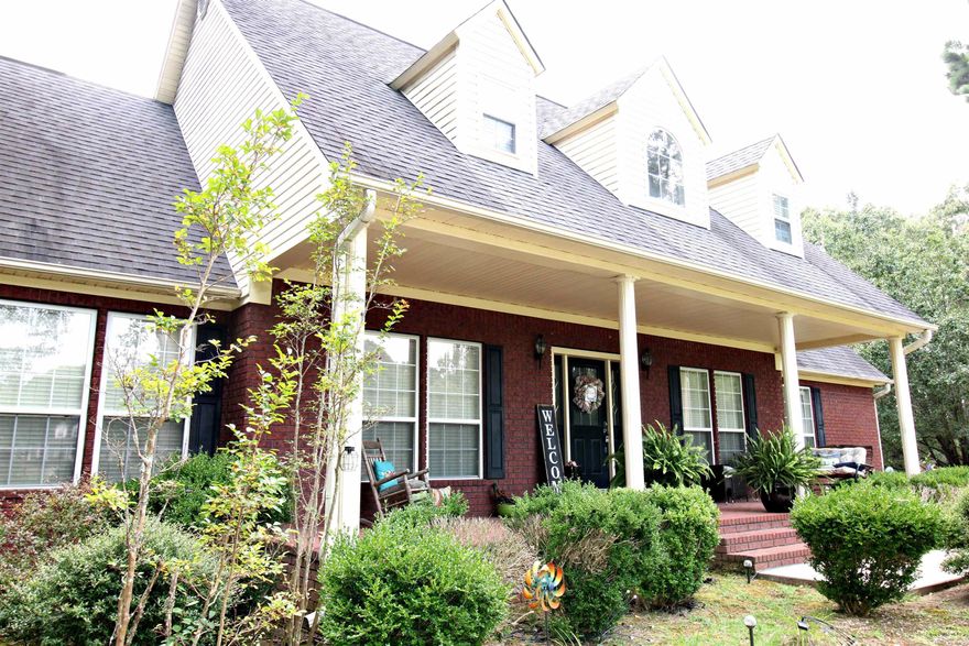 COUNTRY LIVING CLOSE TO TOWN is where you will find this BEAUTIFUL 4BR/3.5BA Brick home with 3122 sq ft! Paved drive leads to 3.86 Acres with small pond and mature shade trees. Fabulous front porch with lovely landscaping  is a great place to relax and hear the birds sing after a long day. Step inside to an open floor plan with stunning staircase and soaring columns. Hardwood floors. Great Room gives you plenty of room for the family to hang out. Brick FP with Pellet stove. Kitchen has lots to offer with Pantry, stainless appliances and refrigerator stays. Breakfast area plus formal DR. Primary suite on main level,  spacious for large BR furniture along with sitting area and Elec Fireplace. Primary bath w/Jacuzzi Tub and stand up shower, plus walk in closet. Curl up with a good book in the cozy sunroom or slip out to the patio to grill dinner. 2 BR/1BA upstairs- PLUS- BONUS ROOM upstairs that could serve multi-purposes.(man-cave, office, music/hobby/movie room! BUT WAIT... there's MORE- IF... you have the need for parents or guest to stay over there's a MIL/Guess Suite with its own bath/shower. 2 Car Garage, RV/Boat Shed, and SO MUCH MORE! Call today to see this Peaceful Paradise!