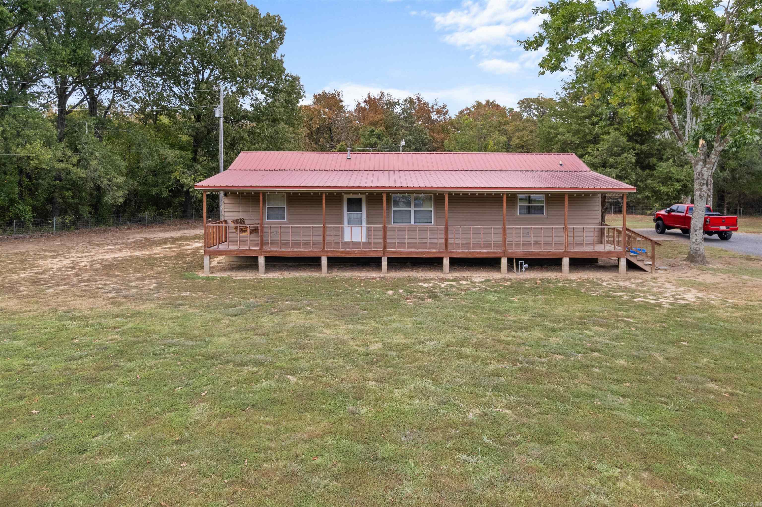 Rare Find! Welcome to this cute and immaculate country home! Upon arriving at the property you will notice the property is fully fenced w/gate at the road. Entering the property you see the large covered front deck and the rear covered deck too. Not to mention the shop and more onsite as well! Entering the home you immediately are welcomed by the fresh and clean neutral tones of paint throughout the home. The Living Room is centrally located w/a spacious Eat in Kitchen and Bath off the rear of the home. Also off the Living Room is the hallway and guest bedrooms as well as the Master Bedroom and Bath too! The Master Bedroom faces rear on the home as well. This home boasts a combination of tile, laminate and vinyl floors for easy cleaning and maintenance too. On the property you have a garden space as well as a chicken coop space too. The home is covered by vinyl siding and a metal roof. The approx 24x30 shop is a metal building shop with metal roof too. You will want to see this home if you are seeking a home with a little acreage. See Agent Remarks.