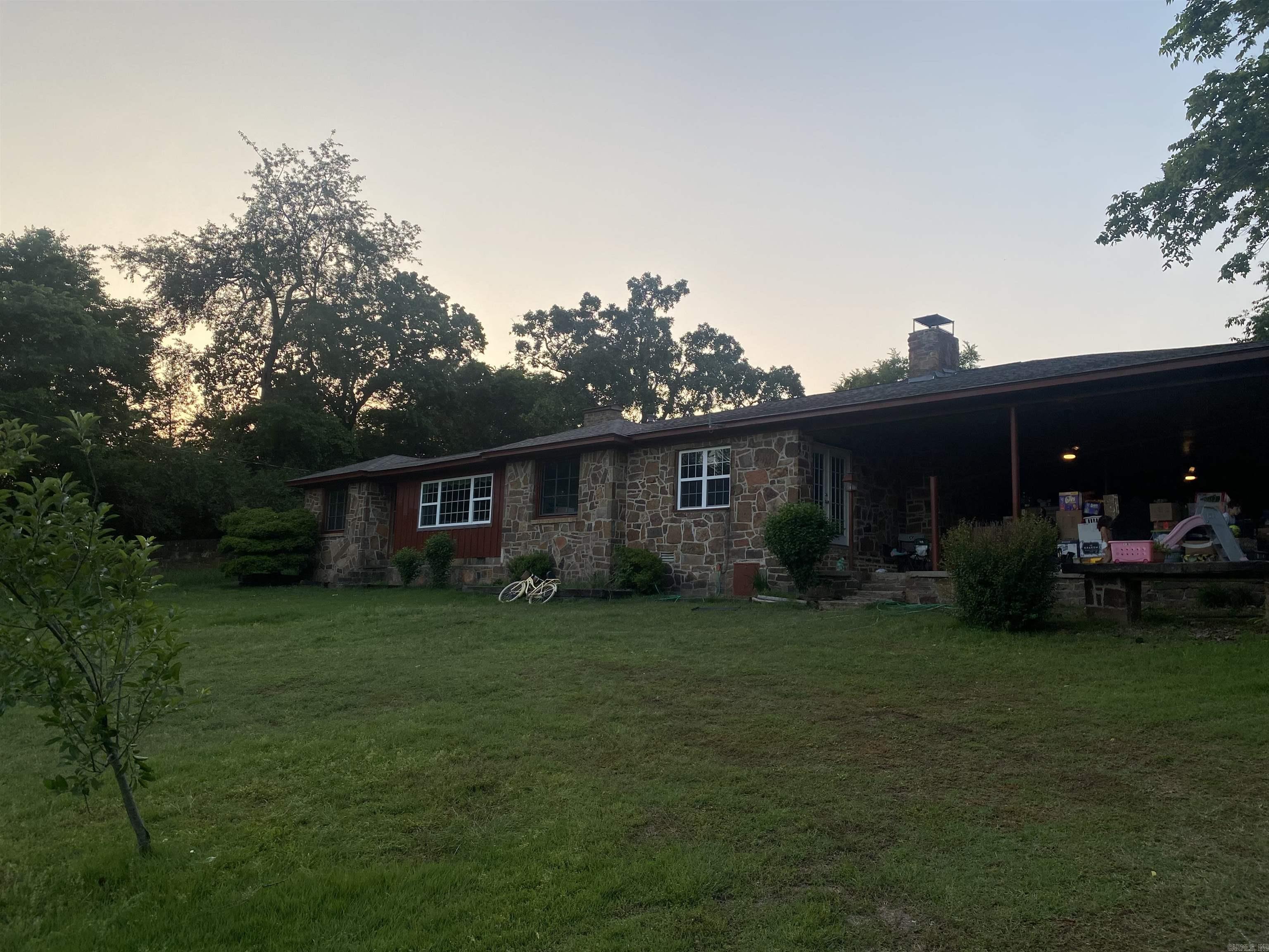 Come check out this charming home that has been kept as serene as possible. In the heart of Booneville on the Ridge, it's sure to have all the views and the seclusion you want! With a great carport that can double as a sweet hang out spot, to the two living spaces, cozy fireplace and even tucked in little office space, this one is a gem! Original hardwood floors throughout and fresh paint! Come check it out!