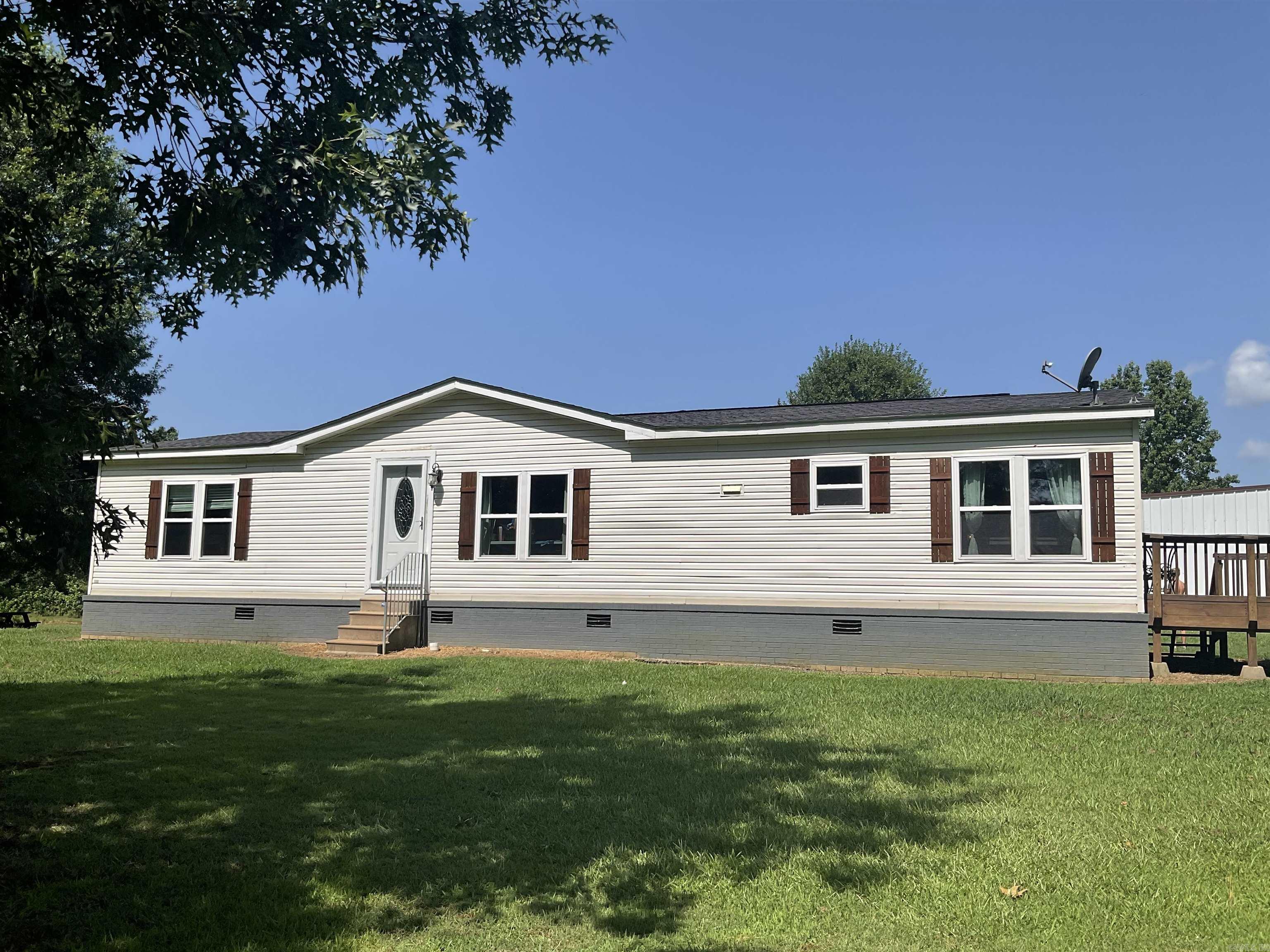 Quiet country living just minutes from all of Searcy's amenities. 3/2 bath setting on 3.3 acres. Recent renovations, including new energy efficient windows. Large deck for above ground pool, pond, playground area with wooden jungle gym for the kids, 30 x 35 shop, shops siding was replaced in 2023, shop has half bath and bar area for entertaining. Home is on a permanent foundation with brick under pinning. Roof was replaced in February of 2020. Schedule your appointment today! Agents see remarks.