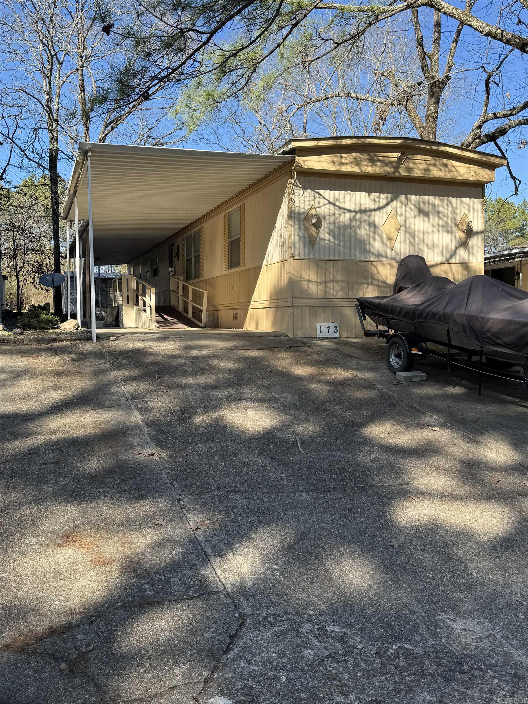 Larger two bedroom/ two bath MH has a big open space for living, dining and kitchen. Carport and patio area has a ramp for the door entrance. LOCATION and LOW PRICE are the vocal points of this MH in a 55 and older neighborhood. Close to Oaklawn Racing Casino Resort, shopping and hospital/medical facilities!