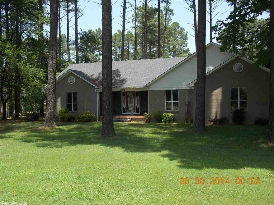 Nicer brick home with several nice updates, sits on peaceful huge lot with beautiful large trees.  Shop, privacy fence, dog fence, new storm shelter, stack stone detailing.  Screened in large back porch, newer lighting, tile flooring, stacked stone fireplace, vaulted ceiling in kitchen and breakfast area, tray ceiling in large living room, additional area could be 4th bedroom, office, den, or formal dining.  HUGE master suite with walk in closet, and dbl closet.