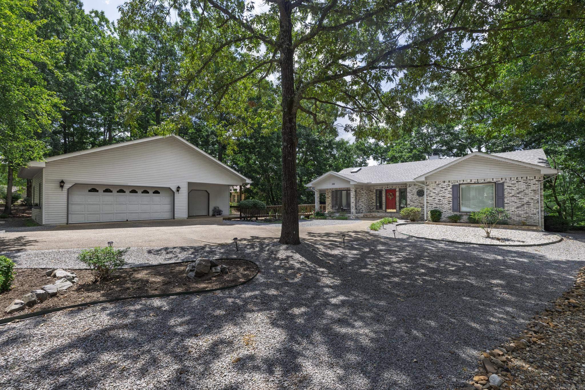 Custom built home with amazing views of Lake Balboa. The main level features a kitchen with solid wood cabinetry and separate butler pantry. The living/dining area overlooks the lake. On the same level, the master bedroom features a walk-in closet and nice master bath. On the lower level, the great room with bar overlooks the lake with large, picturesque windows and also has two bedrooms, one of which also acts as a storm shelter. Outside the lower level are stairs leading down to the newly installed covered boat dock. The home has storage galore, including a nice walkway connecting the home to the two-car garage with heated and cooled workshop and an upstairs area. Grill on deck which is piped to the propane tank will convey. Roof is new! Some furnishings negotiable. Call today as this one will go quick! 501.912.4575.