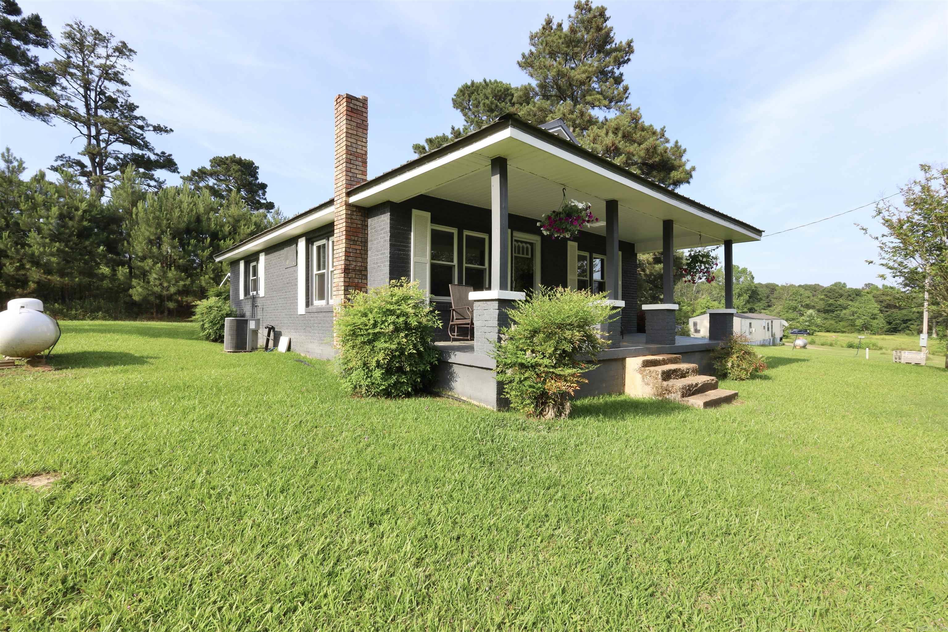 This charming 1 bed, 1 bath house is the perfect size for a starter home or a weekend retreat! Completely remodeled in 2016, this home has a new roof, new windows, new sheetrock throughout, all new bathroom, granite countertops in kitchen and bathroom, new luxury vinyl plank flooring, new roof on storage building, new single carport, new water heater installed in 2023, new paint throughout in 2023 and more! Home is all electric plus a propane space heater in the living area. Home can easily be converted back to a 2 bedroom. There is an additional 160 sq. ft. enclosed back porch where the washer and dryer are housed as well as ample storage space. Located just 4 miles from the Little Missouri River, 5 miles from Lake Greeson, 28 miles from Crater of Diamonds State Park and 54 miles from Hot Springs, this property is close enough to amenities while still offering the comforts of rural living. Call today to schedule your showing! Owner is agent.