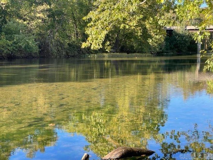 This beautiful South Fork Spring River land for sale is mostly wooded & gently rolls down to the river.  At 0.57 acres m/l, this land for sale is a perfect spot to build your dream home.   Located on a paved road with electric & water available.  There is a cleared, chat driveway from the road down to the stones along the bank of the river. Located in Cherokee Village, Arkansas,  a popular destination for retirees, families, and vacationers in the Ozark Mountains of Sharp & Fulton County, Arkansas.  If you are looking for a place to relax and enjoy the natural beauty of the Ozarks, Cherokee Village is the perfect place for you.   Cherokee Village is also a great place to retire, with a variety of services that cater to seniors.  The village also offers a wide range of amenities, including: lakes for boating, fishing, and swimming, two 18-hole golf courses, swimming pools, a private beach, tennis courts, recreation/sport centers, fitness and senior centers, horseshoe pits, nature trails and so much more.  The village offers a low cost of living, excellent schools, and four distinct seasons.