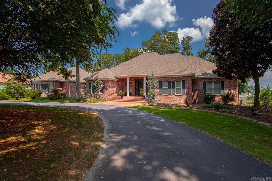 Stunning lakefront home boasting 220 feet of seawall on Hurricane Lake offers breathtaking views from all areas of the home! Gorgeous hardwood floors in the living spaces, including the open kitchen with large island, gas cooktop, dual wall ovens, an ice maker, & a walk-in pantry! The hearth room/dining room offers a gas fireplace and stunning lake views! The spacious primary bedroom features a cozy fireplace, a massive his-&-hers closet with lots of built-ins, custom tile shower, luxurious soaking tub, & two toilets! Additionally, there are two versatile rooms on the main level that can serve as bdrms, an office, or any other desired space. Upstairs, you'll find 2 bdrms, 2 baths, a bonus/living area, heated/cooled storage area, walk-in attic space, & a dedicated heated/cooled exercise/craft room (not in sf). This exceptional property is equipped with a whole-home generator, recirculating hot water system, a safe room, a spacious 3+ car garage w/ epoxy floors! Outside, a large circle driveway provides ample parking and a level lot and covered private dock complete this idyllic lakeside retreat. New downst HVAC & many new Pella windows (w/ a lifetime warranty)! Agents see remarks!