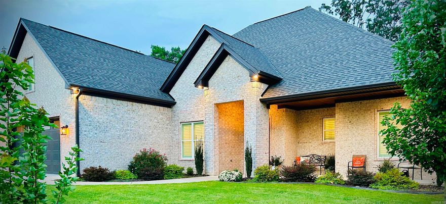 The covered entry and front porch patio area leads to the large front door, which lets in natural light into the generous foyer with two large closets and access to the office/nursery. This Foyer offers only a glimpse into the Luxurious open-concept living area with a Fireplace, large windows for natural light, and very tall ceilings.  The kitchen has custom cabinetry & High End Appliances. This home boasts a "walk-in Pantry" with plenty of room for all your goods and gadgets for the chef. The Primary Bedroom adjoins a luxurious spa bath area with a soaking tub and oversized walk-in shower with a rain head in the ceiling and a shower head on the wall. Shaq wouldn't bump his head in this shower!   2nd bedroom has a walk-in closet and ensuite.  All the bedrooms have custom Plantation Shutters.  Large covered back patio with outdoor kitchen, great for grilling on game day.  Three full bathrooms and a half bath; see this family home today.