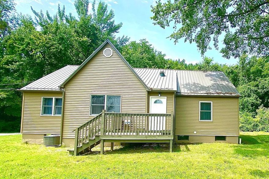 This beautifully remodeled 3-bedroom home in Harrison offers seclusion in a beautiful half acre setting while being right in the middle of town! Upgrades include a modern metal roof, pristine flooring, and fresh exterior vinyl siding. Inside, attention has been given to every detail, with new trim, paint, and a tastefully remodeled kitchen and bathroom. Positioned on a scenic hill, surrounded by majestic trees, the property offers a private and serene atmosphere while remaining conveniently located within minutes of shopping, dining, and entertainment. Don't miss out on this rare opportunity. Make it yours today!