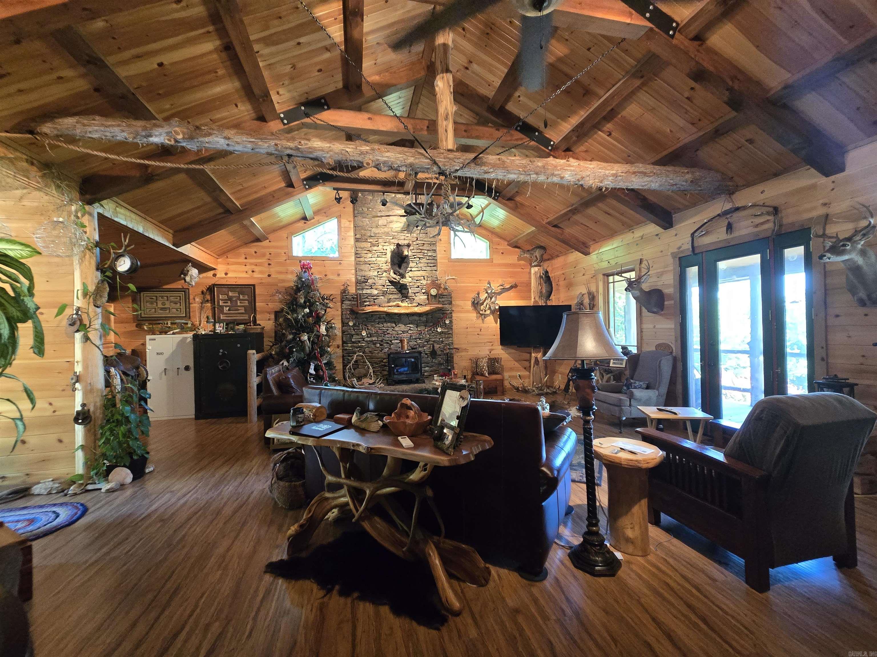 This 57-acre retreat is the ideal setup for hunters and outdoor enthusiasts. Teeming with wildlifeādeer, turkey, and even black bearāthis property offers prime hunting grounds in one of the most scenic parts of the state. The main home is a 2-bedroom, 1-bath cabin showcasing a grand, rustic living room with a vaulted wood-beamed ceiling and a floor-to-ceiling stacked stone fireplace. The covered back porch offers breathtaking views of the rolling hills that stretch for miles. Also on the property is a cozy, lodge-style guest cabin with a kitchenette, full bath, and lofted sleeping spaceāperfect for friends or fellow hunters. Whether you're setting up a hunting camp, a private weekend getaway, or a full-time escape, this one-of-a-kind property delivers.