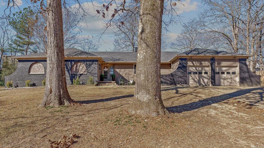 This beautifully updated all-brick home is tucked into a quiet cul-de-sac with a tree-lined setting and inviting outdoor spaces. Offering nearly 2,700 square feet, the 4-bedroom, 3.5-bath layout provides thoughtful design and timeless style throughout. The main living space showcases vaulted ceilings with painted wood beams, dual ceiling fans, and a white-painted brick fireplace with a wood-burning insert and gas line available for gas logs. Built-in shelving and French doors add both character and natural light while creating a seamless flow to the kitchen and dining areas. The kitchen features custom white cabinetry by Norman Quinn Cabinetry, generous counter space, stainless appliances, recessed lighting, and a breakfast bar ideal for everyday living and entertaining. The primary suite is spacious and private with hardwood flooring and a walk-in tiled shower. One secondary bedroom includes a private bath, offering flexibility for guests or a second suite, while additional bedrooms are well-sized with hardwood flooring. A separate half bath adds convenience for guests. Outside, enjoy a fenced backyard with patio space and deck.