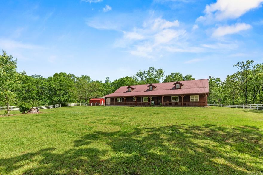 Spacious 4-Bedroom Home on Nearly 10 Acres with Shop and Storage – A Rare Find! This well-maintained 4 bedroom, 2.5 bath home offers nearly 2,700 square feet of comfortable living space on 9.94 mostly wooded acres, blending privacy with convenience. Inside, you'll find central heat and air, a welcoming front porch, cozy fireplace, a two-car attached garage. The kitchen features abundant custom cabinetry, stainless steel sink, wall oven, electric cooktop, and it opens to a large dining room, perfect for family meals or entertaining. The spacious den is large enough to accommodate a pool table or media area. Enjoy security and peace of mind with a built-in ADT alarm system. Step outside to the back deck or relax in your fenced backyard, newly enclosed with a white PVC privacy fence. The property also includes a red iron 30x40 shop with a concrete apron, ideal for hobbies, equipment, or extra storage, as well as a new storage building. Whether you're looking for a quiet homestead, place to spread out, home with shop space, wooded acreage, this checks all the boxes. Call to schedule your private showing!  Call Listing Agent and potentially save thousands on extra buyers agency fees.